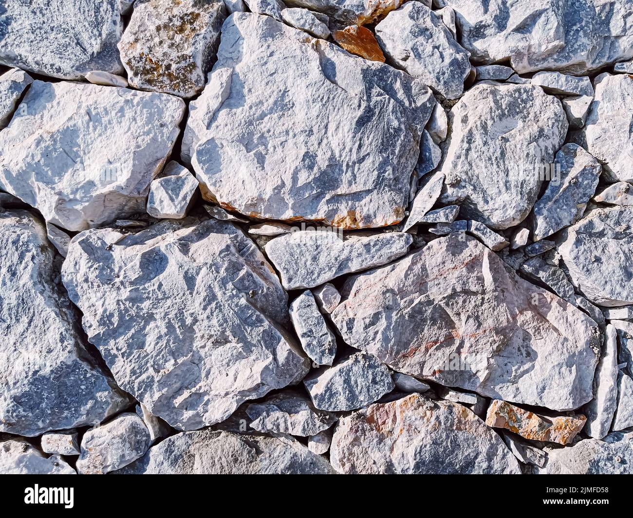 Stone texture and exterior design concept. Stonewall made of natural rocks as architectural