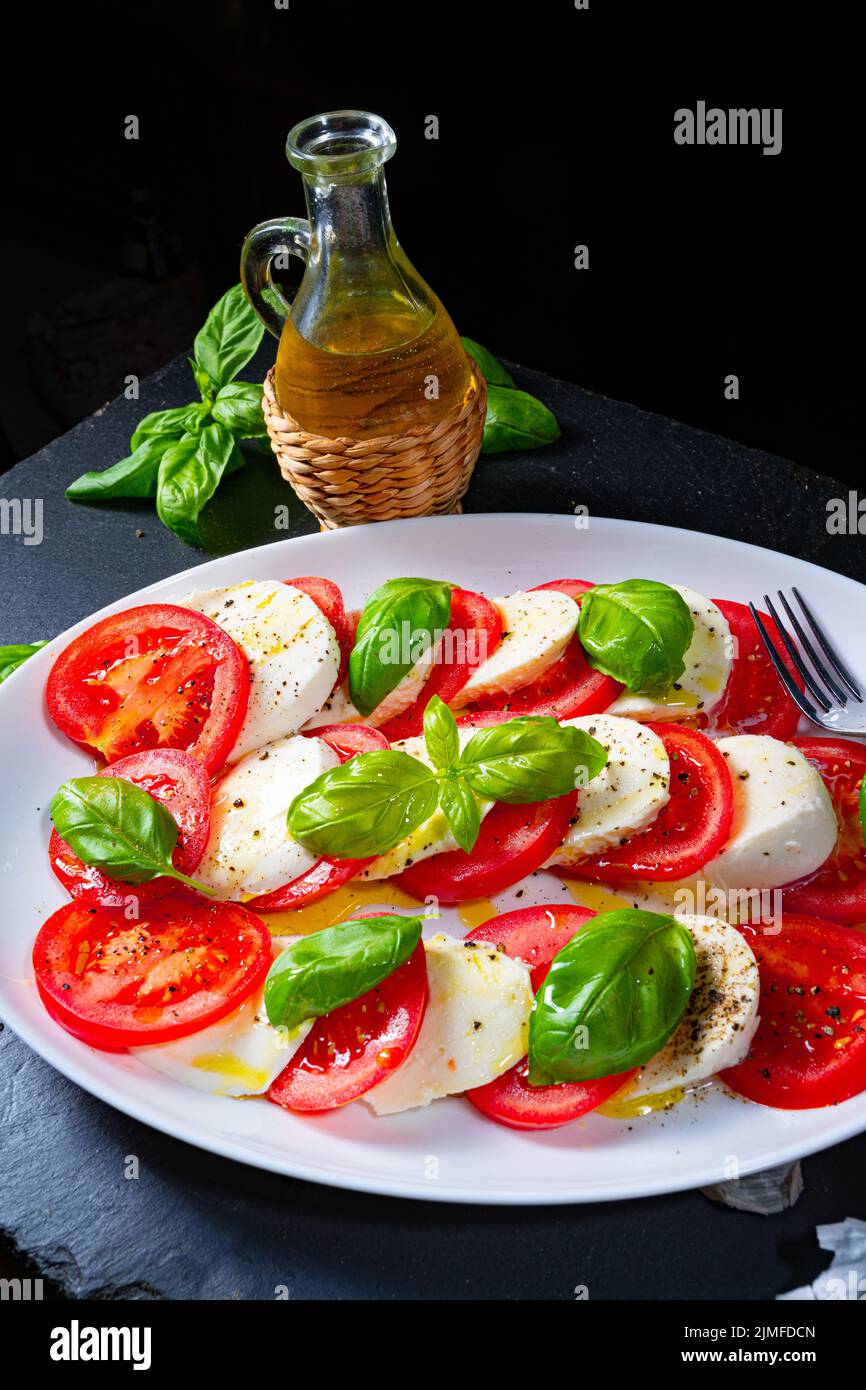 Tomato with mozzarella and basil Stock Photo