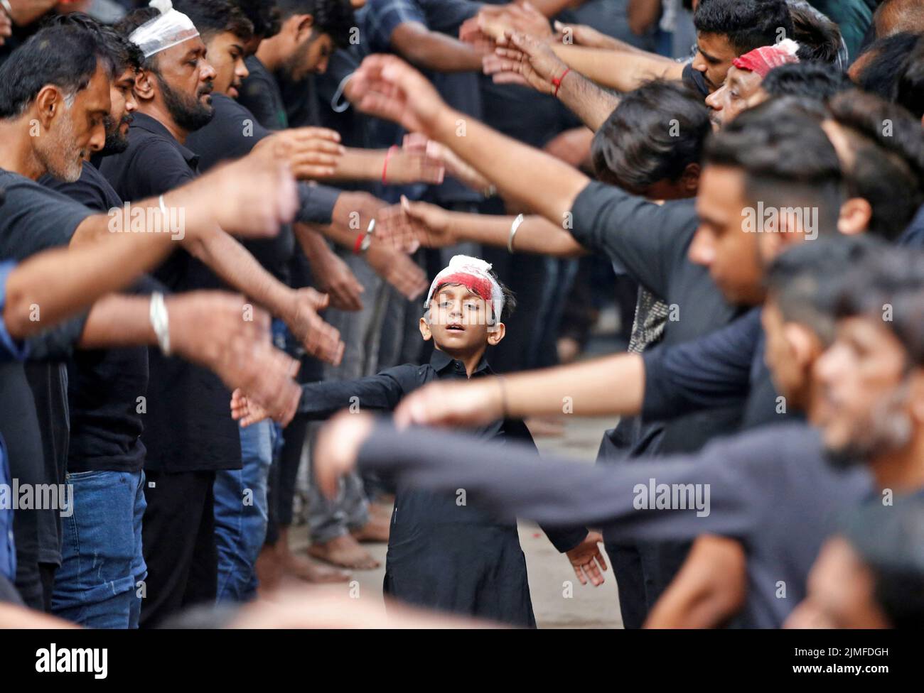 Shi'ite Muslim mourners beat their chests during a Muharram procession ahead of Ashura in Ahmedabad, India, August 6, 2022. REUTERS/Amit Dave Stock Photo