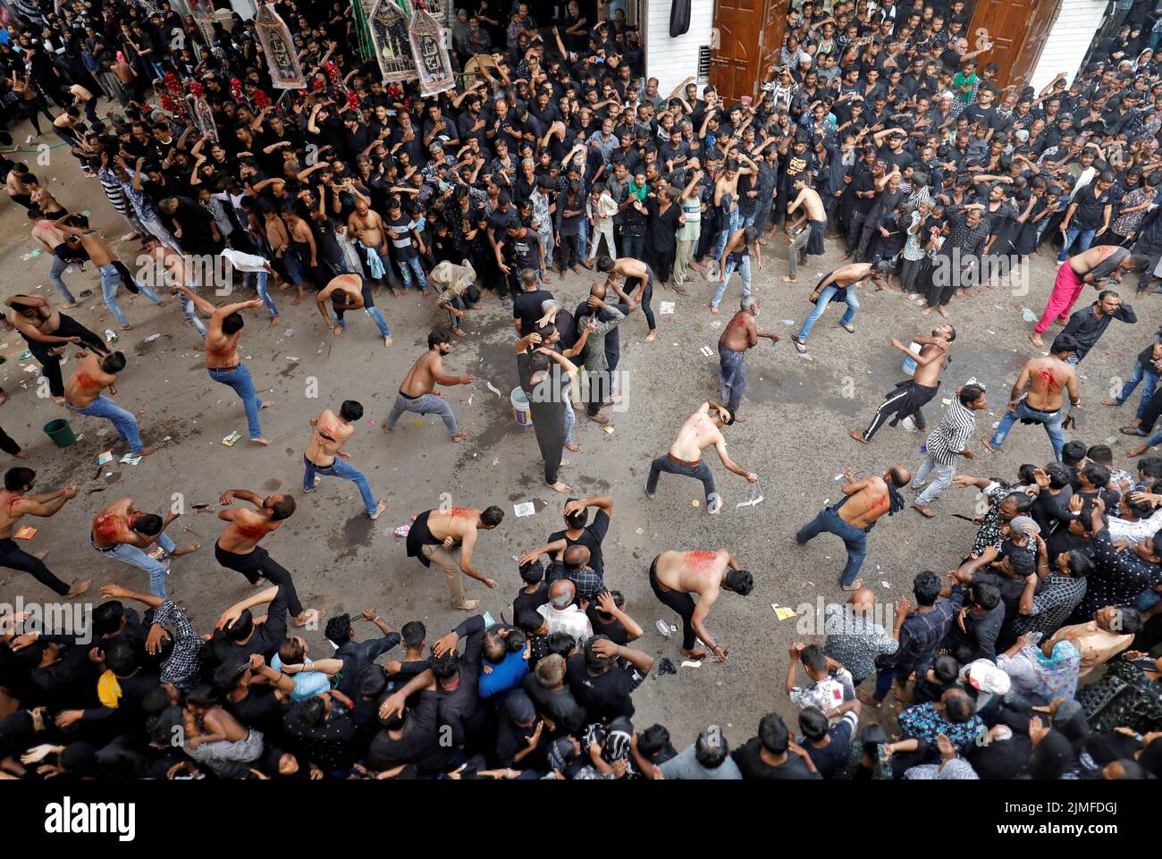 Shi'ite Muslim mourners flagellate themselves during a Muharram procession ahead of Ashura in Ahmedabad, India, August 6, 2022. REUTERS/Amit Dave Stock Photo
