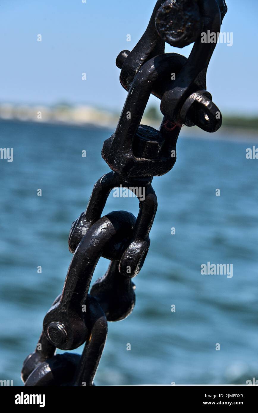 A vertical closeup shot of details on a thick metal boat chain Stock Photo