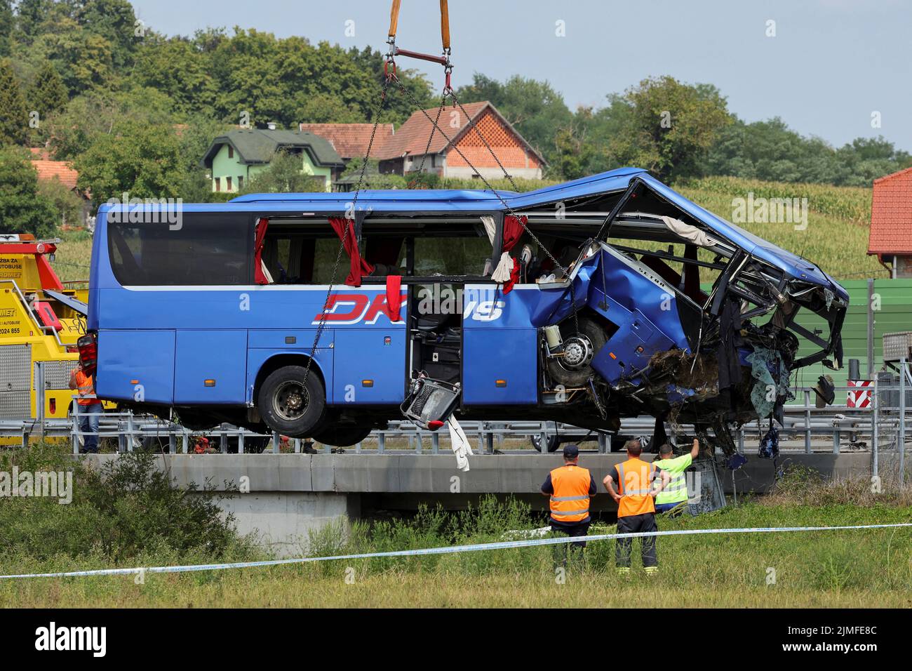 A crane removes the bus with Polish licence plates that slipped off a road, from the scene near Varazdin, northwestern Croatia, August 6, 2022. REUTERS/Antonio Bronic Stock Photo