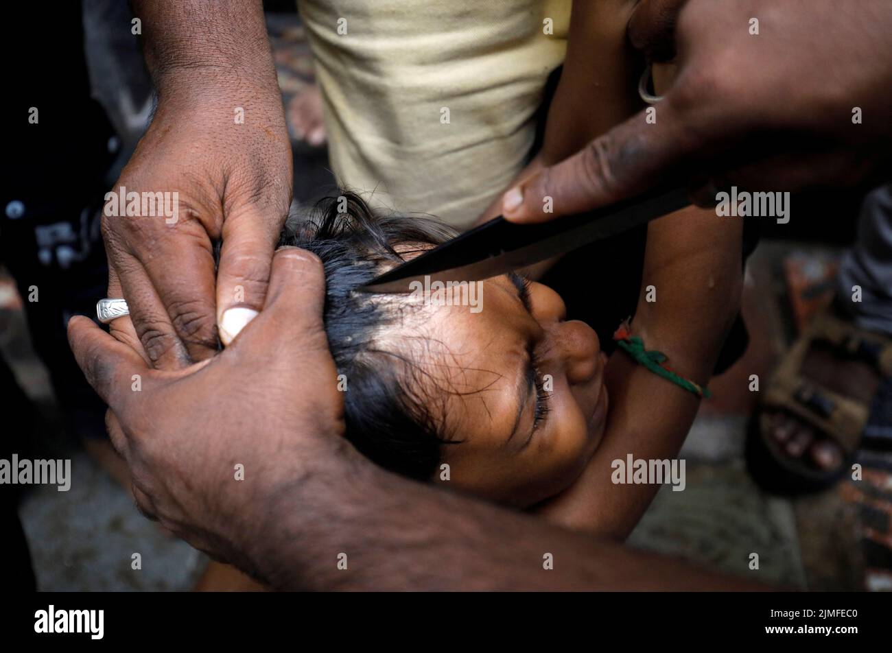 A Shi'ite Muslim boy has his head gashed during a Muharram procession ahead of Ashura in Ahmedabad, India, August 6, 2022. REUTERS/Amit Dave     TPX IMAGES OF THE DAY Stock Photo