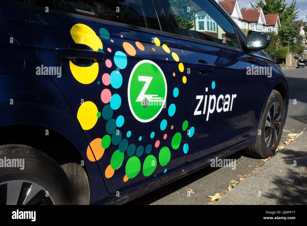 Closeup of a colourful Zipcar logo - an American car-sharing company car on a street in London, England, UK Stock Photo