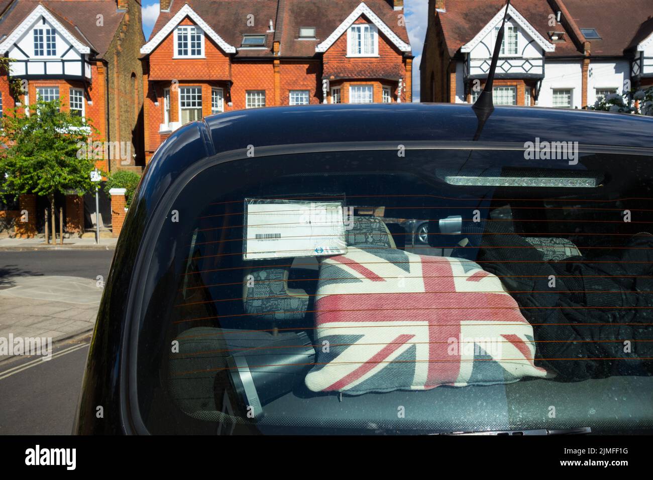 Closeup of a Union Jack cushion in the rear window of a London Black Taxi Cab Stock Photo