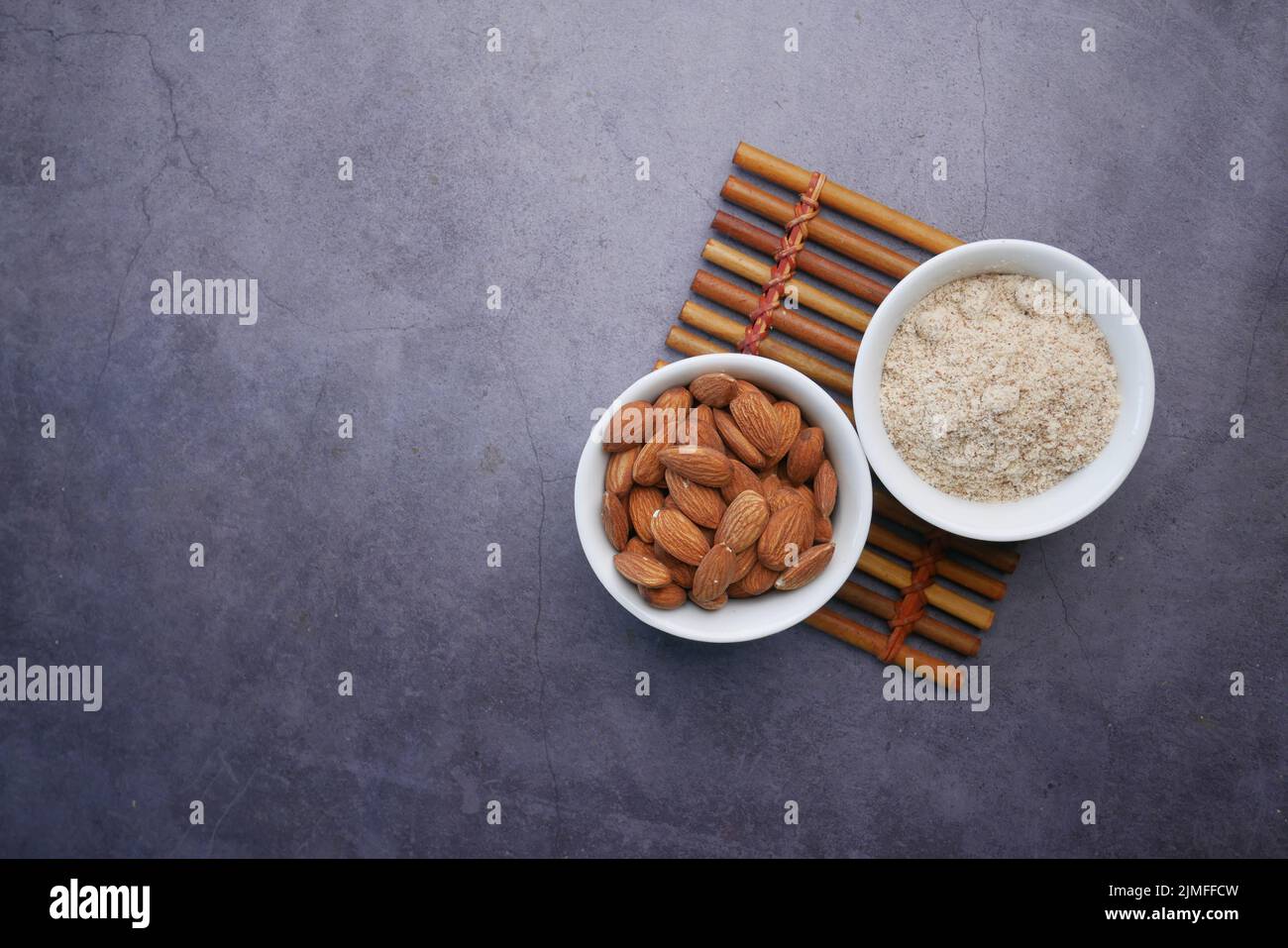 almond powder and almond in a jar on table Stock Photo - Alamy