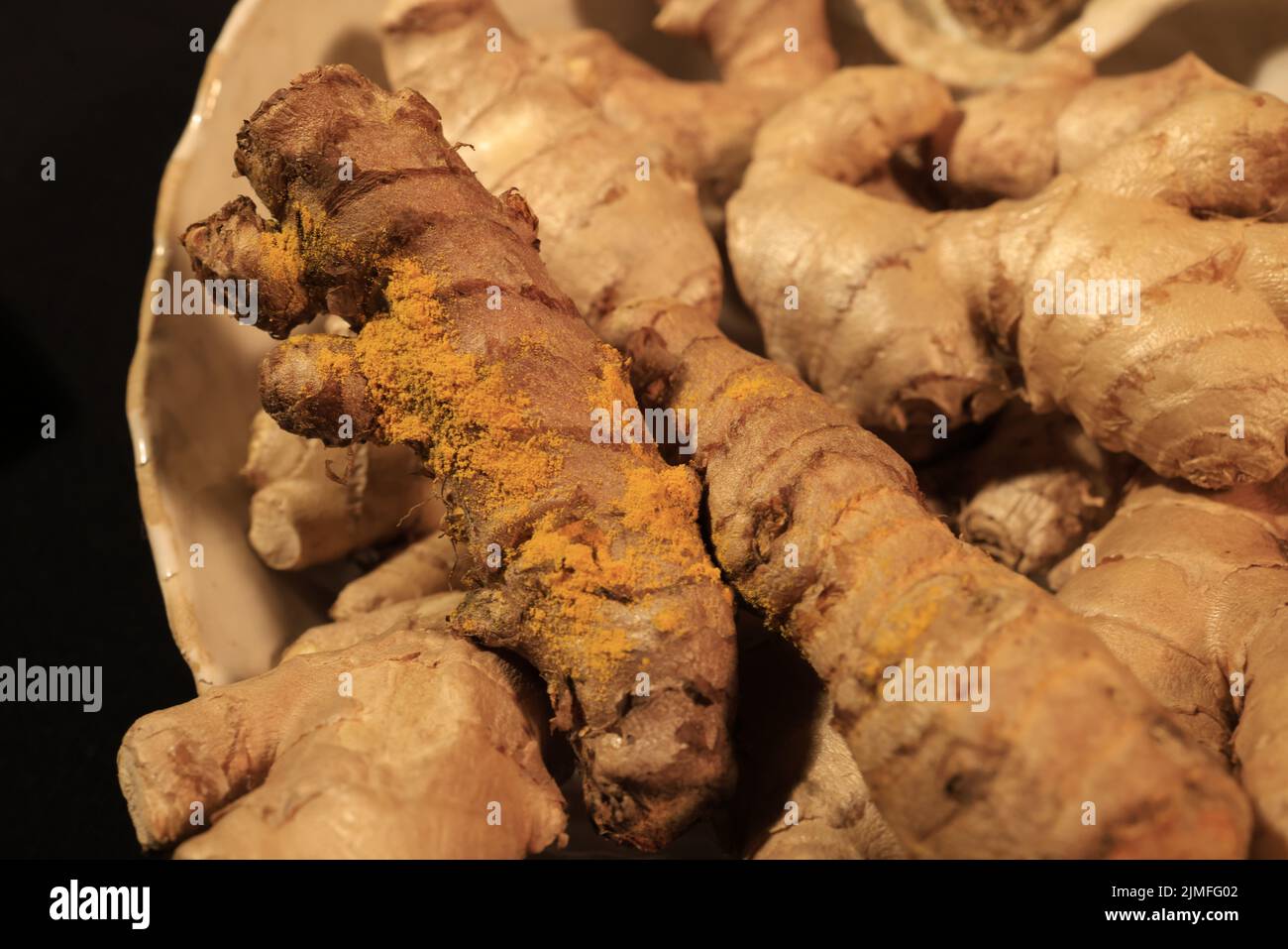 Ginger Roots on a dark background. Stock Photo
