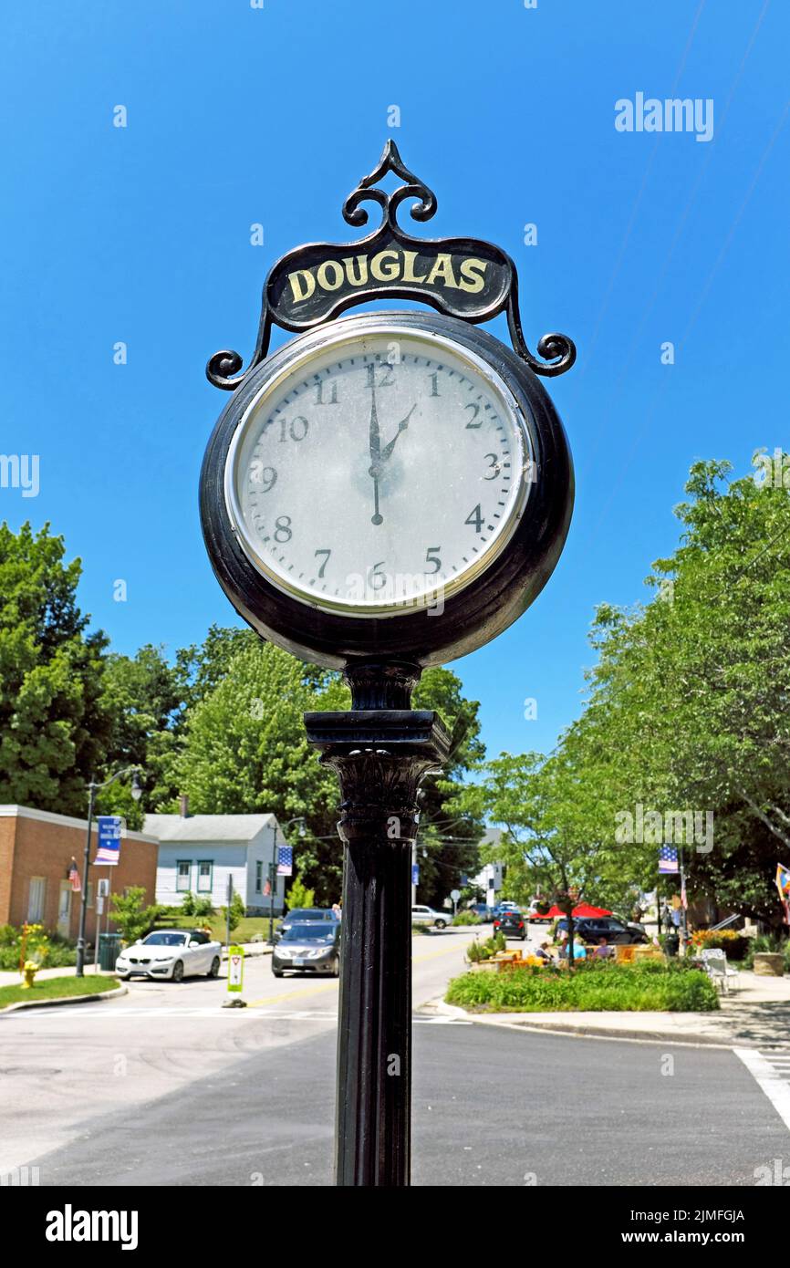 An outdoor street clock shows 1pm on Center Street in the mid-west small resort town of Douglas, Michigan, USA. Stock Photo