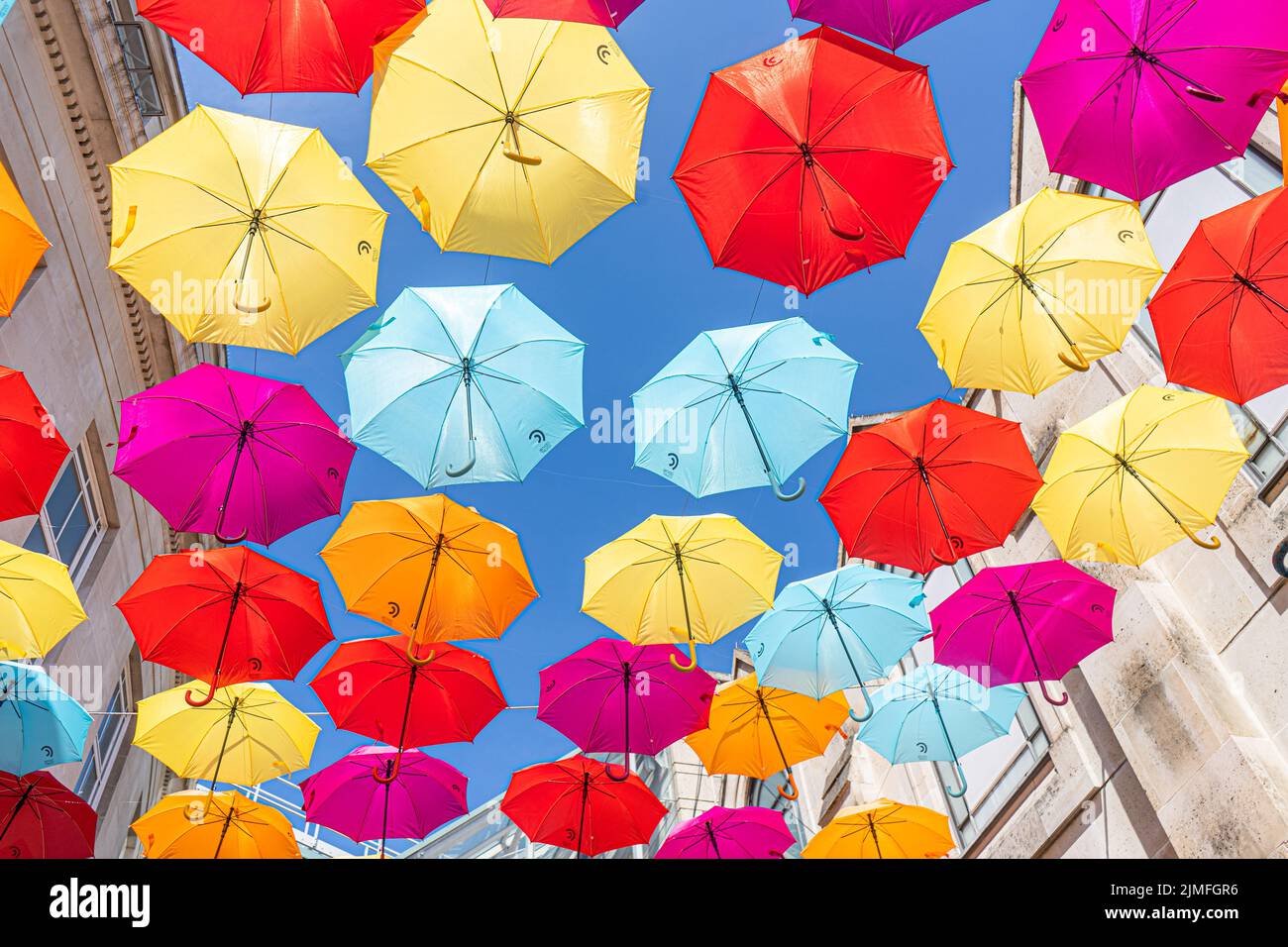 6 August 2022: Colourful umbrellas hanging above a street in the town of Wimbledon, London, UK Stock Photo
