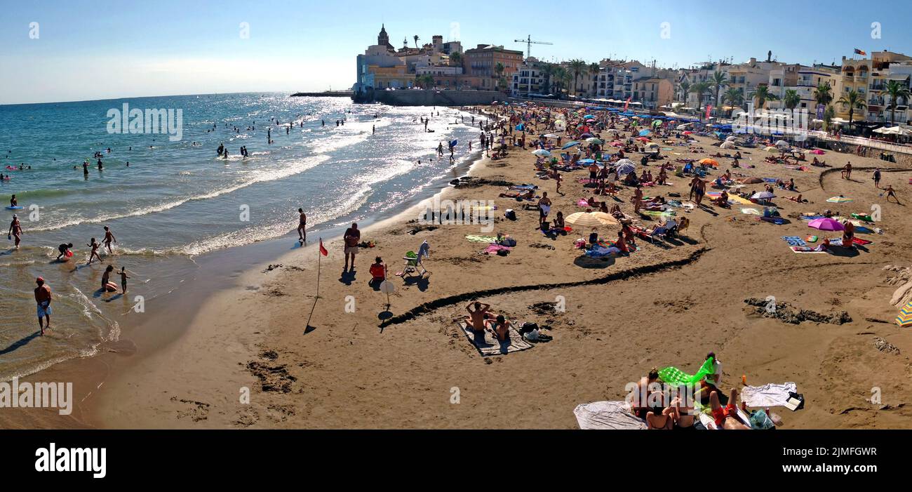 Overview of San Sebastian Beach, also known as Platja de Sant Sebastia, on an August afternoon in Sitges, Spain. Stock Photo