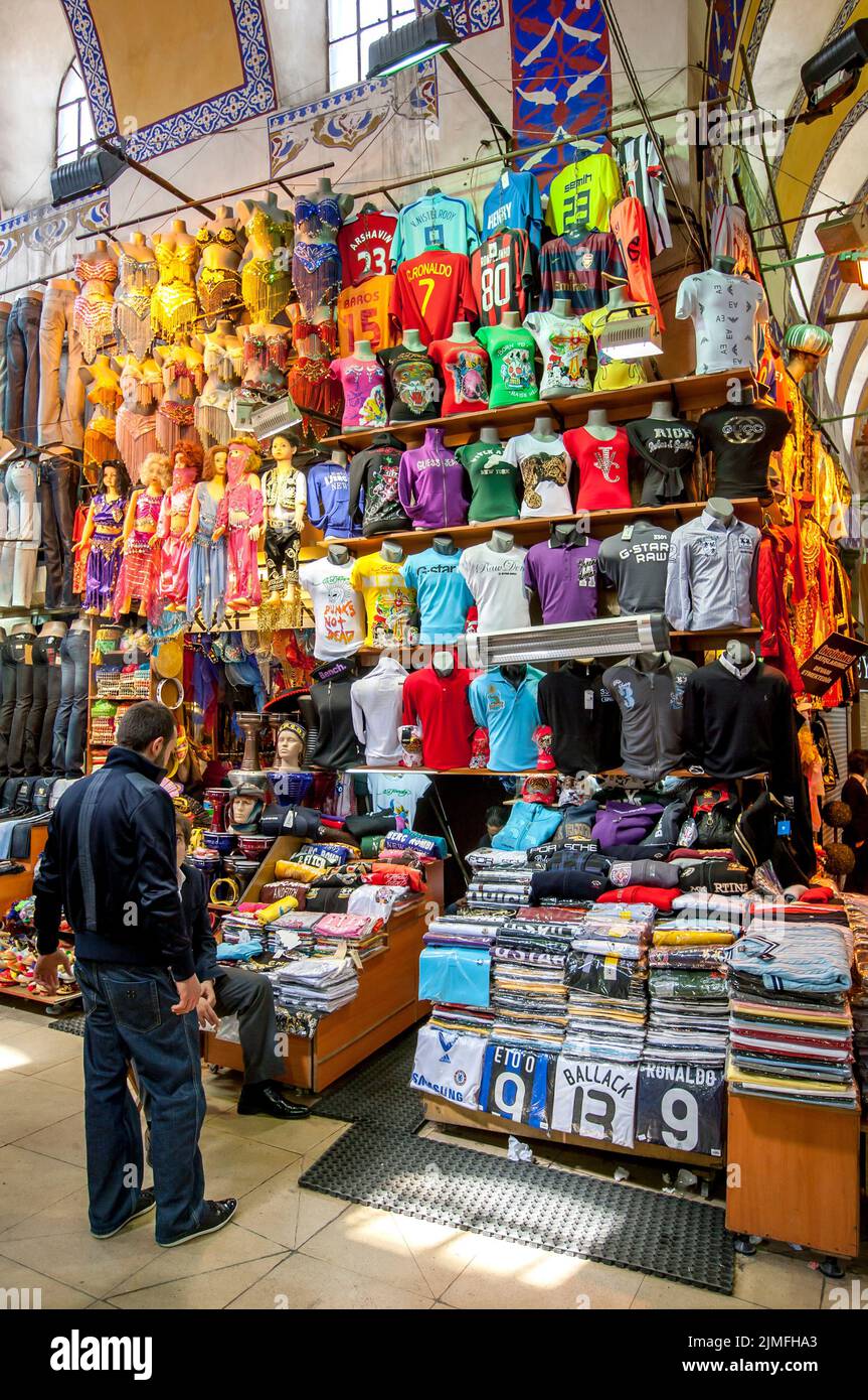 A variety of shirts, jeans and rakass costumes for sale at a stall within the Grand Bazaar at Istanbul in Turkey. Stock Photo