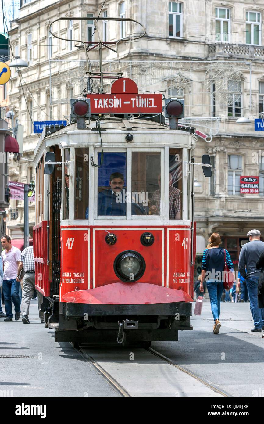 The historic Taksim tram runs along Istiklal Caddesi in the Beyoglu district of Istanbul in Turkey. Stock Photo