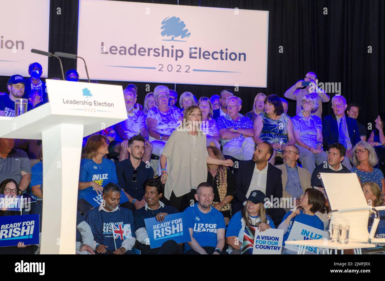 Protestor standing from Green New Deal disrupts Liz Truss at Conservative leadership hustings. Stock Photo