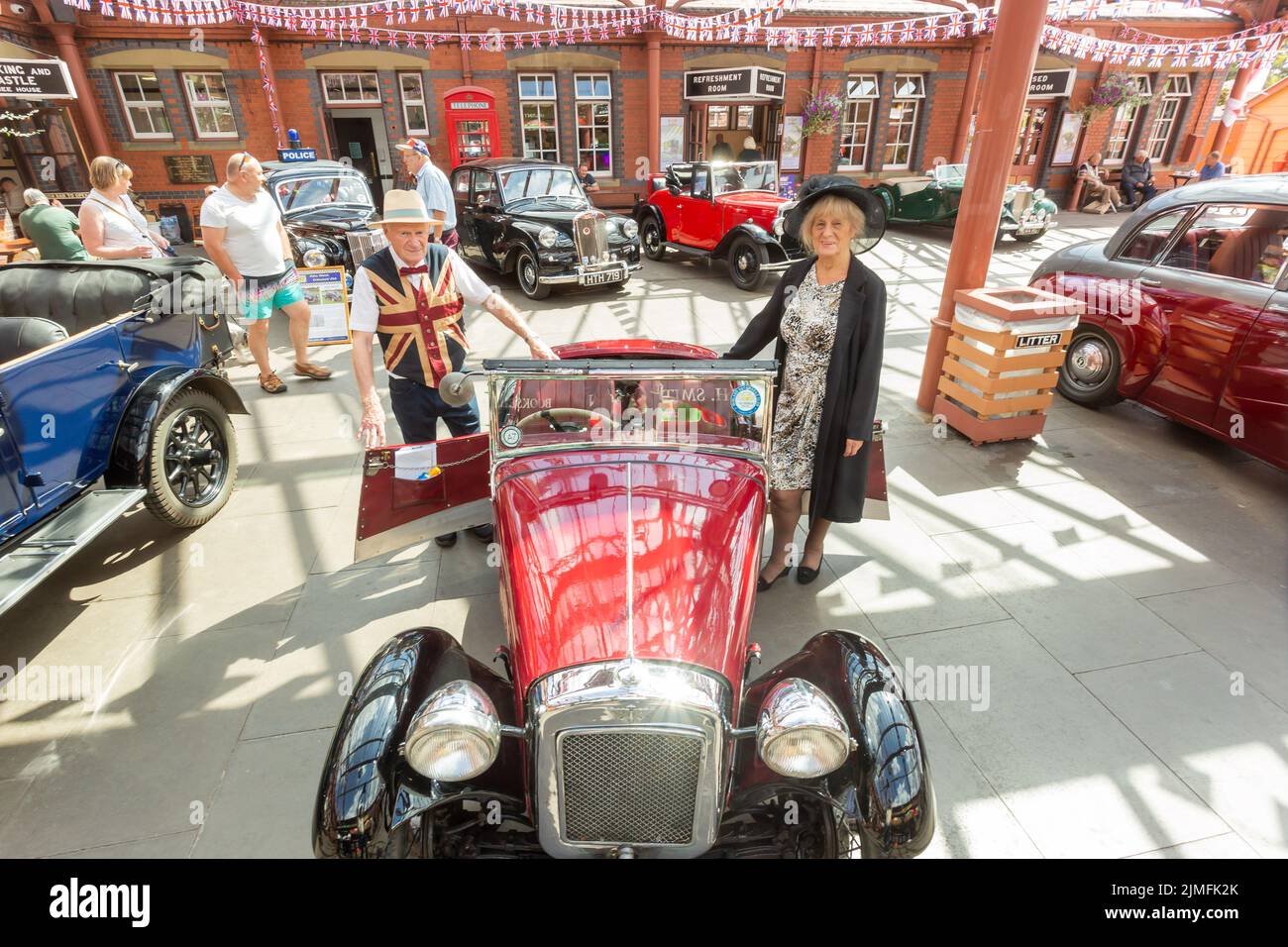 Kidderminster, Worcs, UK. 6th August, 2022.   Jim Tangye Parker, 78, with his partner Margaret Gould, with their pride and joy - a rare aluminium bodied 1933 Austin Seven EB65 Nippy, at the Severn Valley Railway's Vintage Transport Extravaganza. The annual event has steam engines as well as vintage motor vehicles. Credit: Peter Lopeman/Alamy Live News Stock Photo