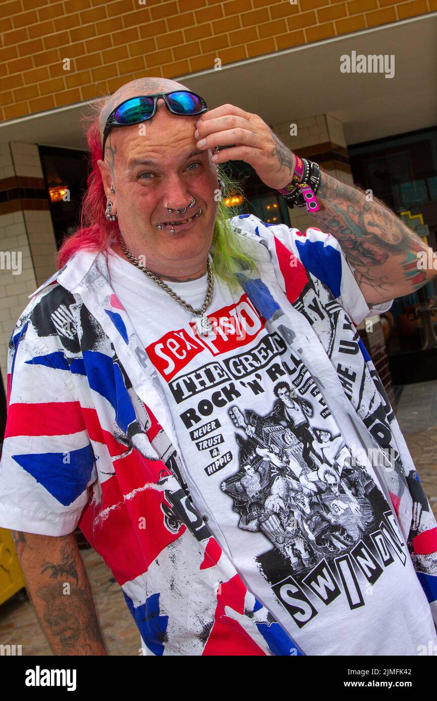 Blackpool, Lancashire, UK. 6th Aug 2022. Sid from the Midlands. The punk subculture, ideologies, fashion, with Mohican dyed hairstyles and colouring at the Punk Rebellion festival at The Winter Gardens. A protest against conventional attitudes and behaviour, a clash of anti-establishment cultures,  mohawks, safety pins and a load of attitude at the seaside town as punks attending the annual Rebellion rock music festival at the Winter Gardens come shoulder to shoulder with traditional holidaymakers.  Credit; MediaWorldImages/AlamyLiveNews Stock Photo