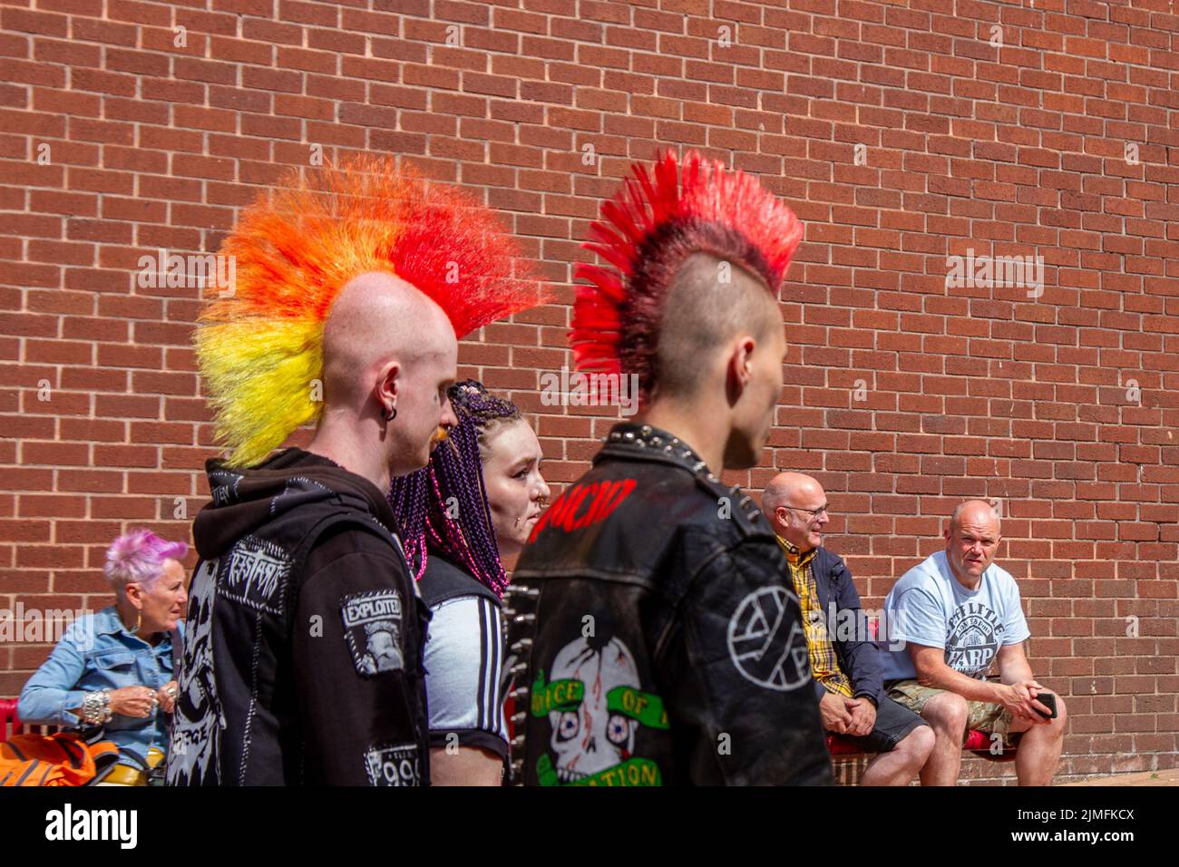 Blackpool, Lancashire, UK. 6th Aug 2022. The punk subculture, ideologies, fashion, with Mohican dyed hairstyles and colouring at the Punk Rebellion festival at The Winter Gardens. A protest against conventional attitudes and behaviour, a clash of anti-establishment cultures,  mohawks, safety pins and a load of attitude at the seaside town as punks attending the annual Rebellion rock music festival at the Winter Gardens come shoulder to shoulder with traditional holidaymakers.  Credit; MediaWorldImages/AlamyLiveNews Stock Photo