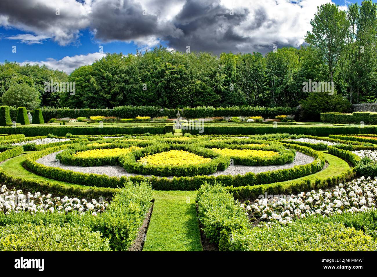 PITMEDDEN GARDEN ABERDEENSHIRE SCOTLAND IN SUMMER YELLOW FLOWERS A CIRCULAR PARTERRE AND HERBACEOUS FLOWER BORDER Stock Photo