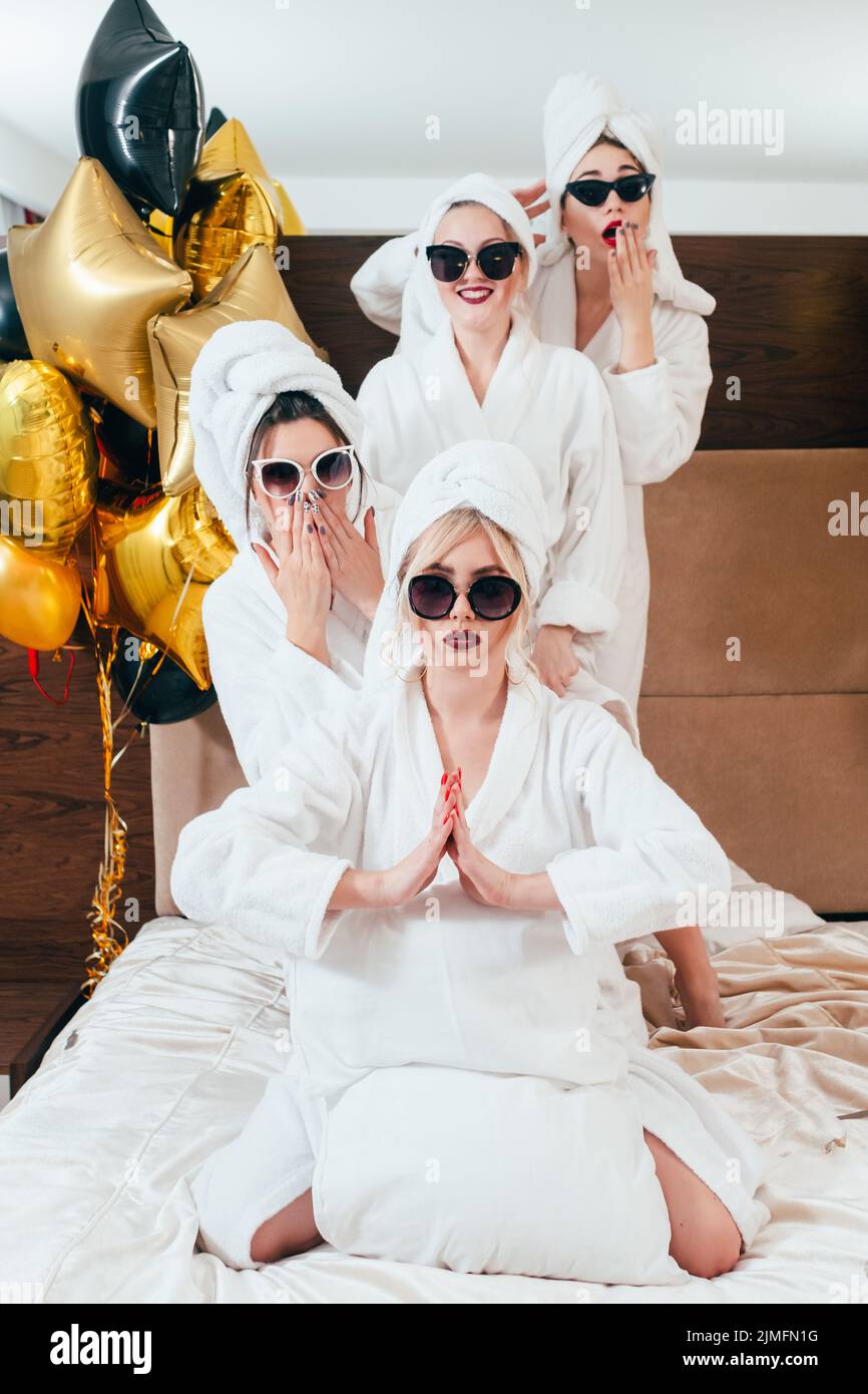 celebration spa party fun women posing bathrobes Stock Photo