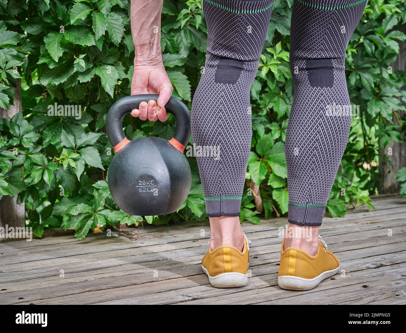 male wearing compression knee and calf braces is exercising with a