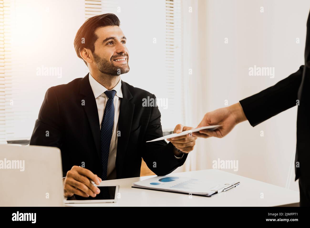 close up hand of company employee receive bonus from manager, getting salary in envelope from boss at working place Stock Photo