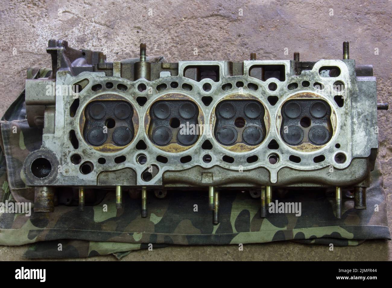 The cylinder head is 16-valve. Part of a car engine. Repair of the internal combustion engine. Stock Photo