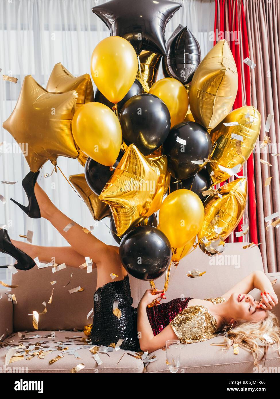 birthday party delighted blonde lady balloons Stock Photo