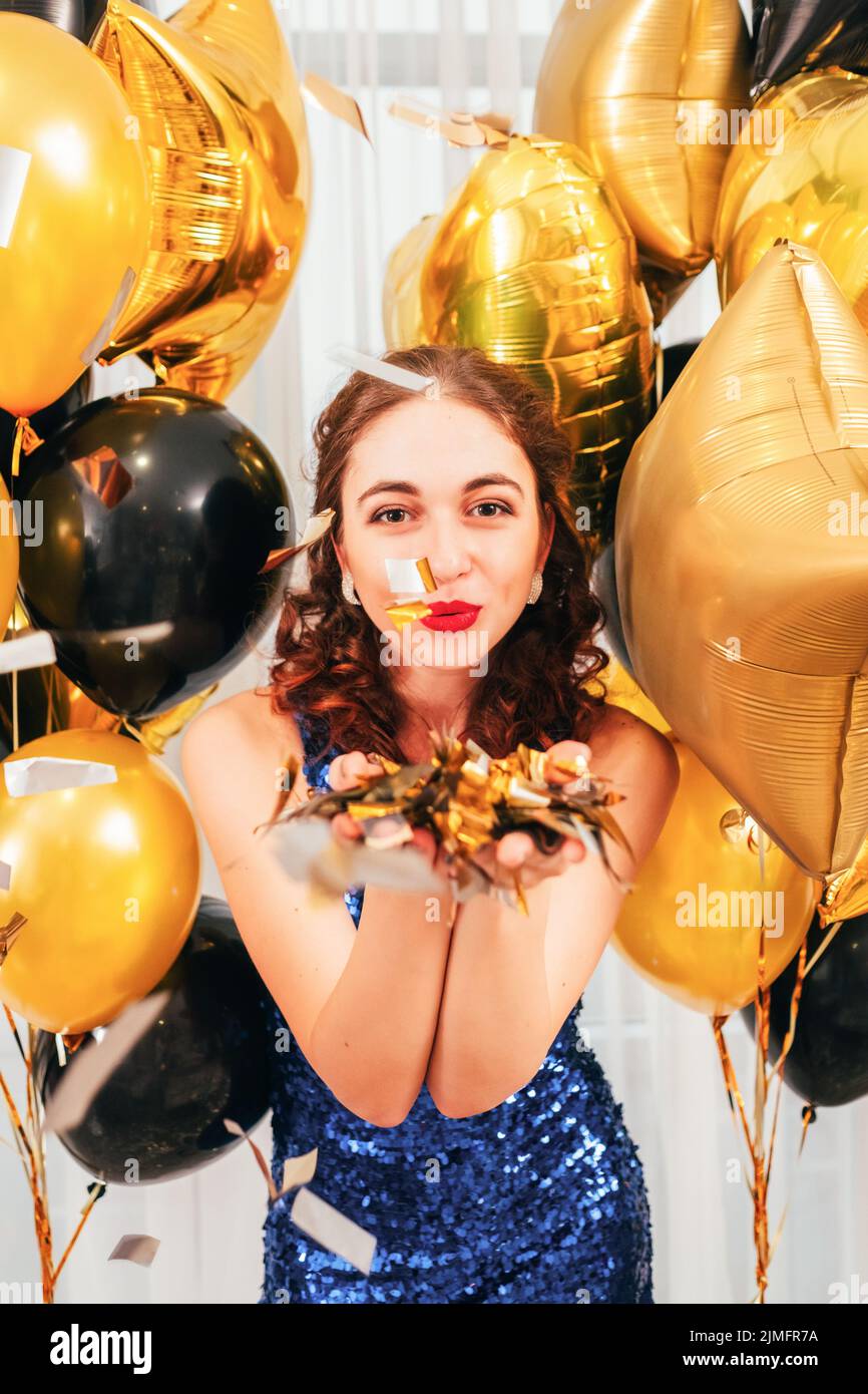 festive occasion balloons girl blowing confetti Stock Photo Alamy