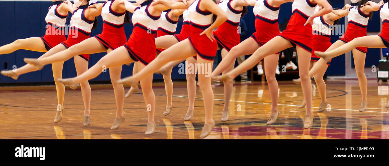 High school kickline group performing during halftime of a basketball