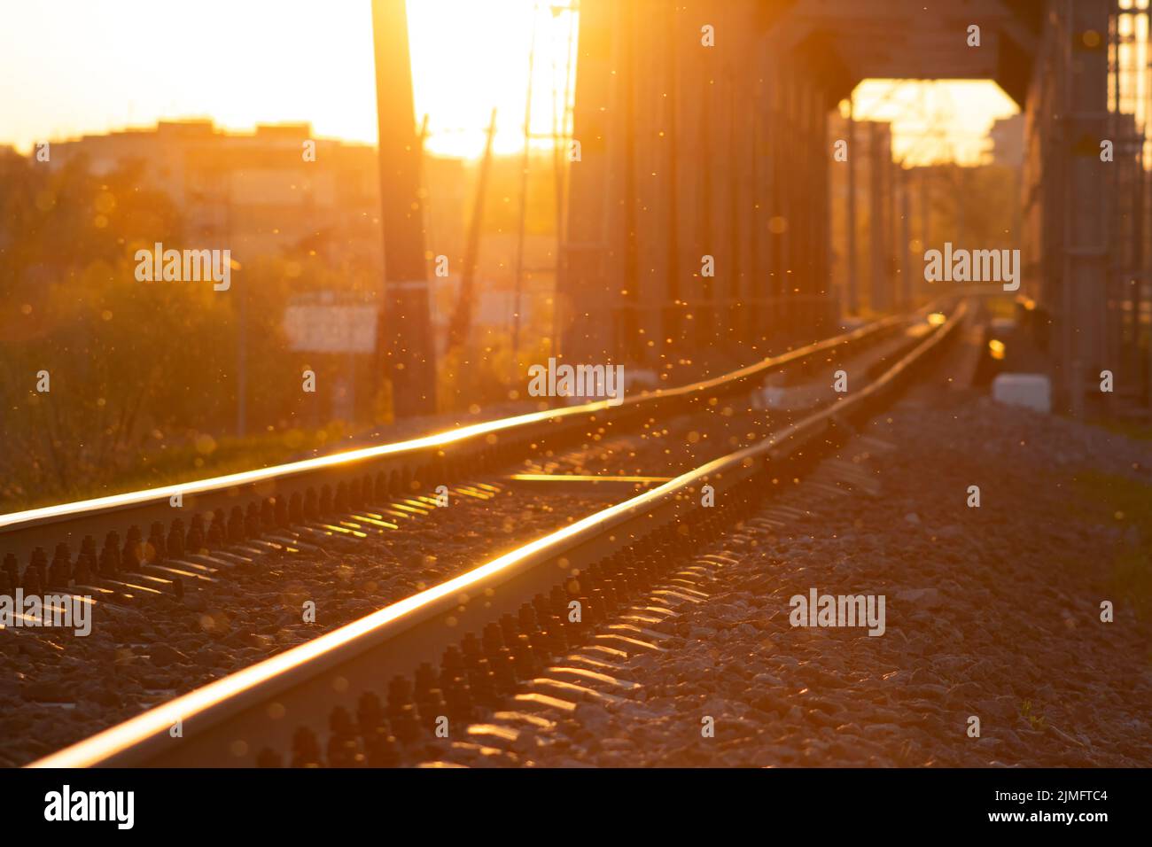 Dust in the air, blur background of railway tracks and bridge. Stock Photo