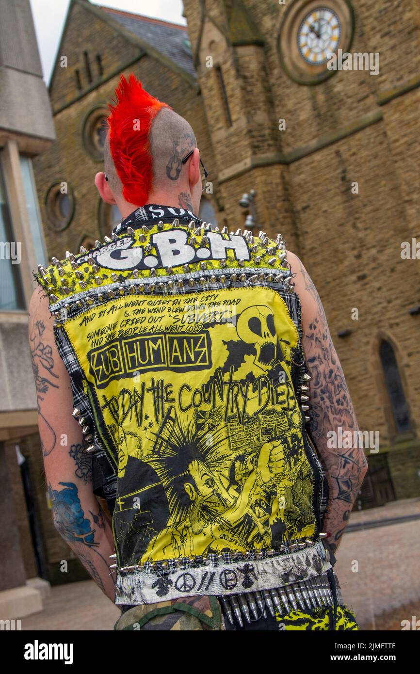 Blackpool, Lancashire, UK. 6th Aug 2022. Reece from Wigan. The punk subculture, ideologies, fashion, with Mohican dyed hairstyles and colouring at the Punk Rebellion festival at The Winter Gardens. A protest against conventional attitudes and behaviour, a clash of anti-establishment cultures,  mohawks, safety pins and a load of attitude at the seaside town as punks attending the annual Rebellion rock music festival at the Winter Gardens come shoulder to shoulder with traditional holidaymakers.  Credit; MediaWorldImages/AlamyLiveNews Stock Photo