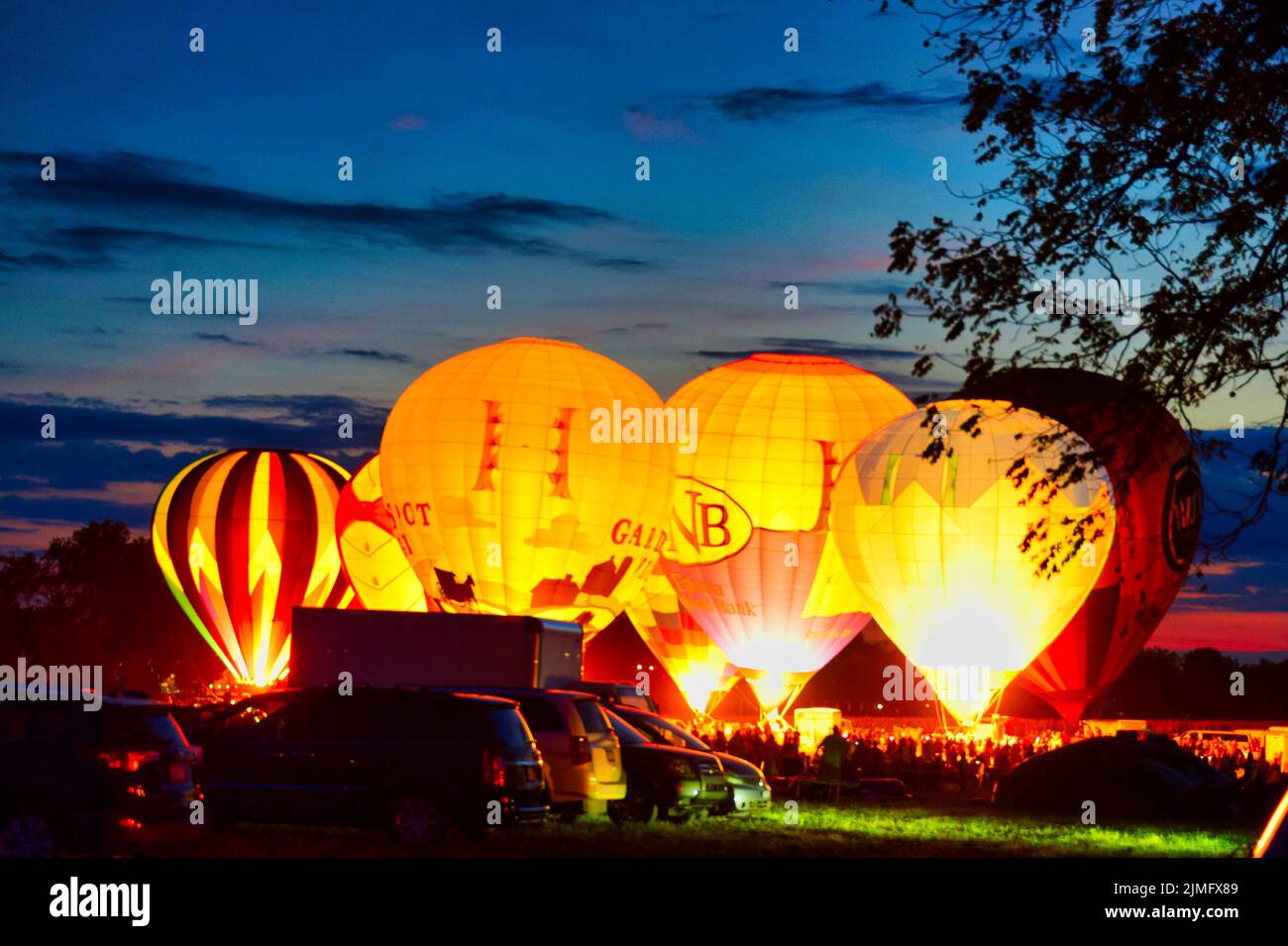Multiple Hot Air Balloon Glow as Balloons Fire There Propane Tanks and Light Up the Balloons