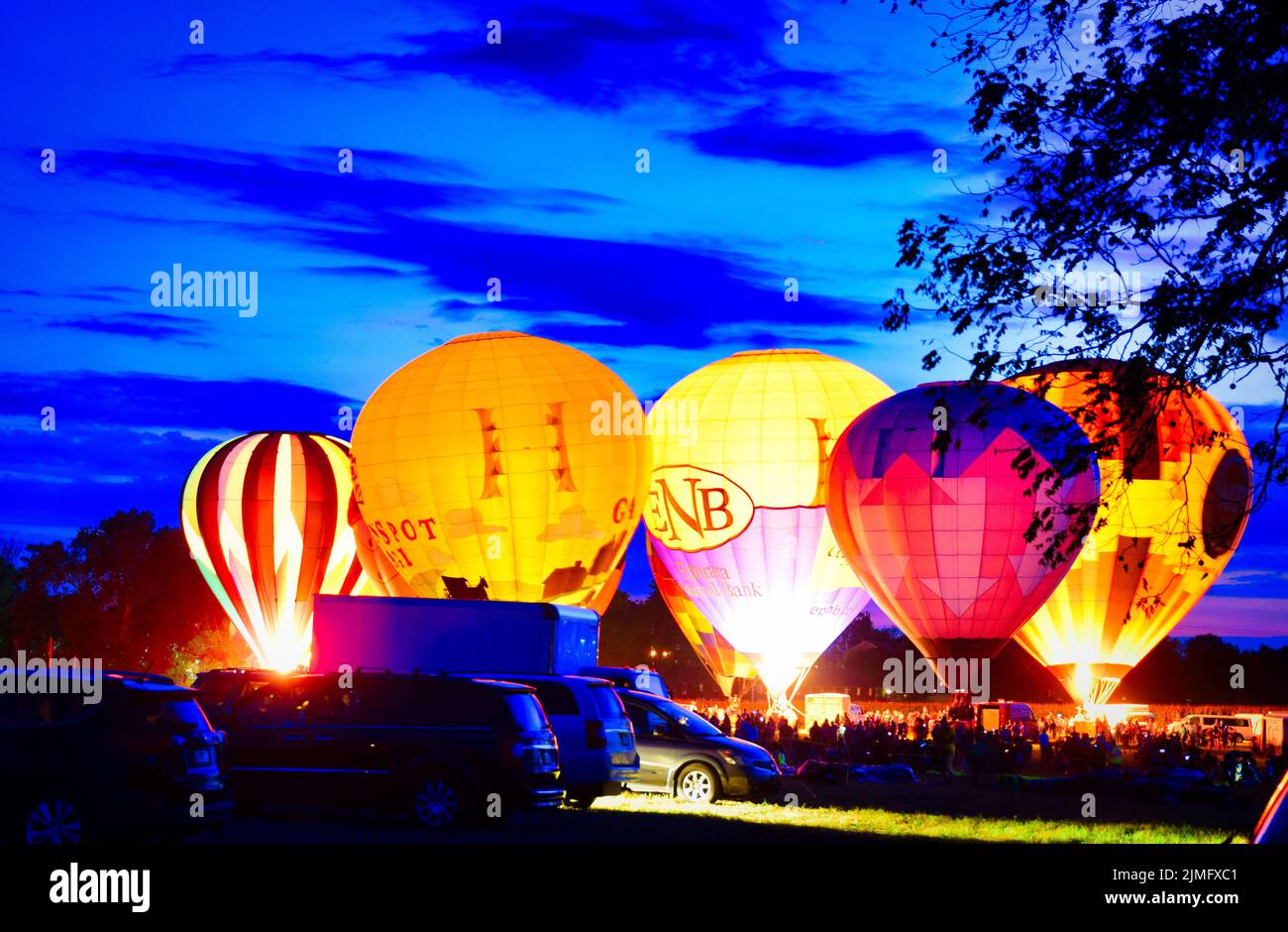 Multiple Hot Air Balloon Glow as Balloons Fire There Propane Tanks and Light Up the Balloons