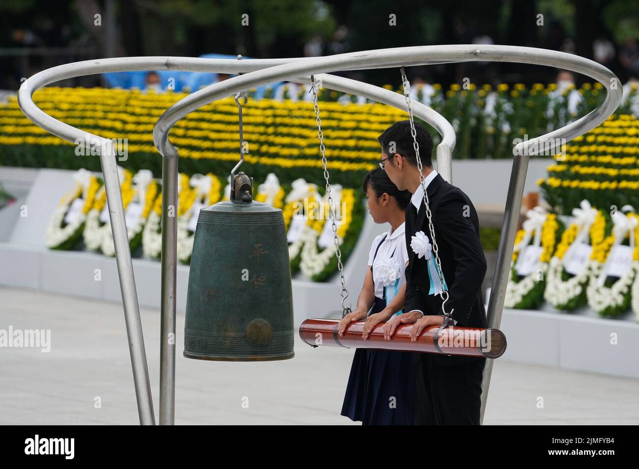 (220806) -- HIROSHIMA, Aug. 6, 2022 (Xinhua) -- People strike the bell to mark the 77th anniversary of the atomic bombing of Hiroshima in Hiroshima, Japan, Aug. 6, 2022. Japan marked the 77th anniversary of the atomic bombing of its western city of Hiroshima on Saturday. While Japan inwardly looks at the tragedies it had experienced at the end of World War II, historians and political minds of the international community have encouraged Japan to come to see themselves not as merely victims of the atomic bombings but also as the perpetrators who led to these tragic incidents to happen in the Stock Photo