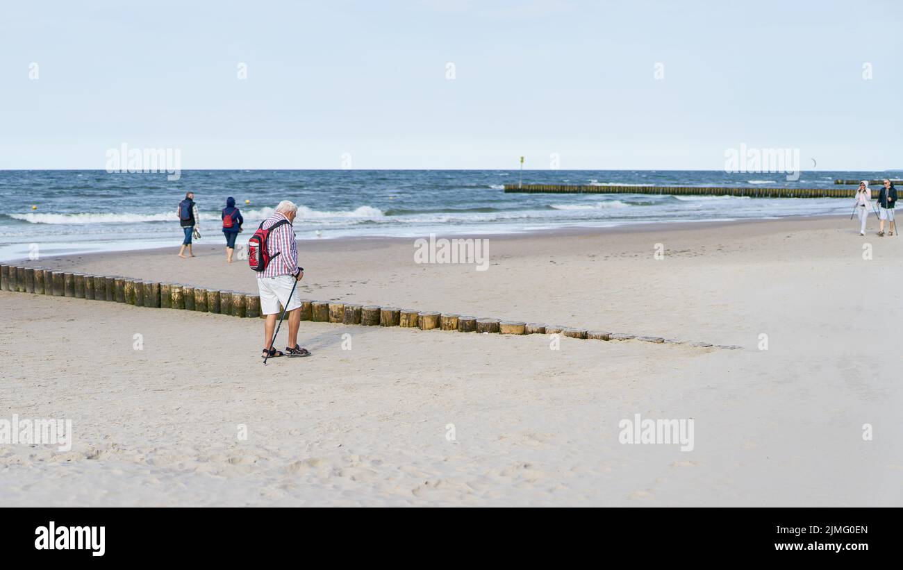 Strollers on the beach of Kolobrzeg on the Polish coast of the Baltic Sea Stock Photo