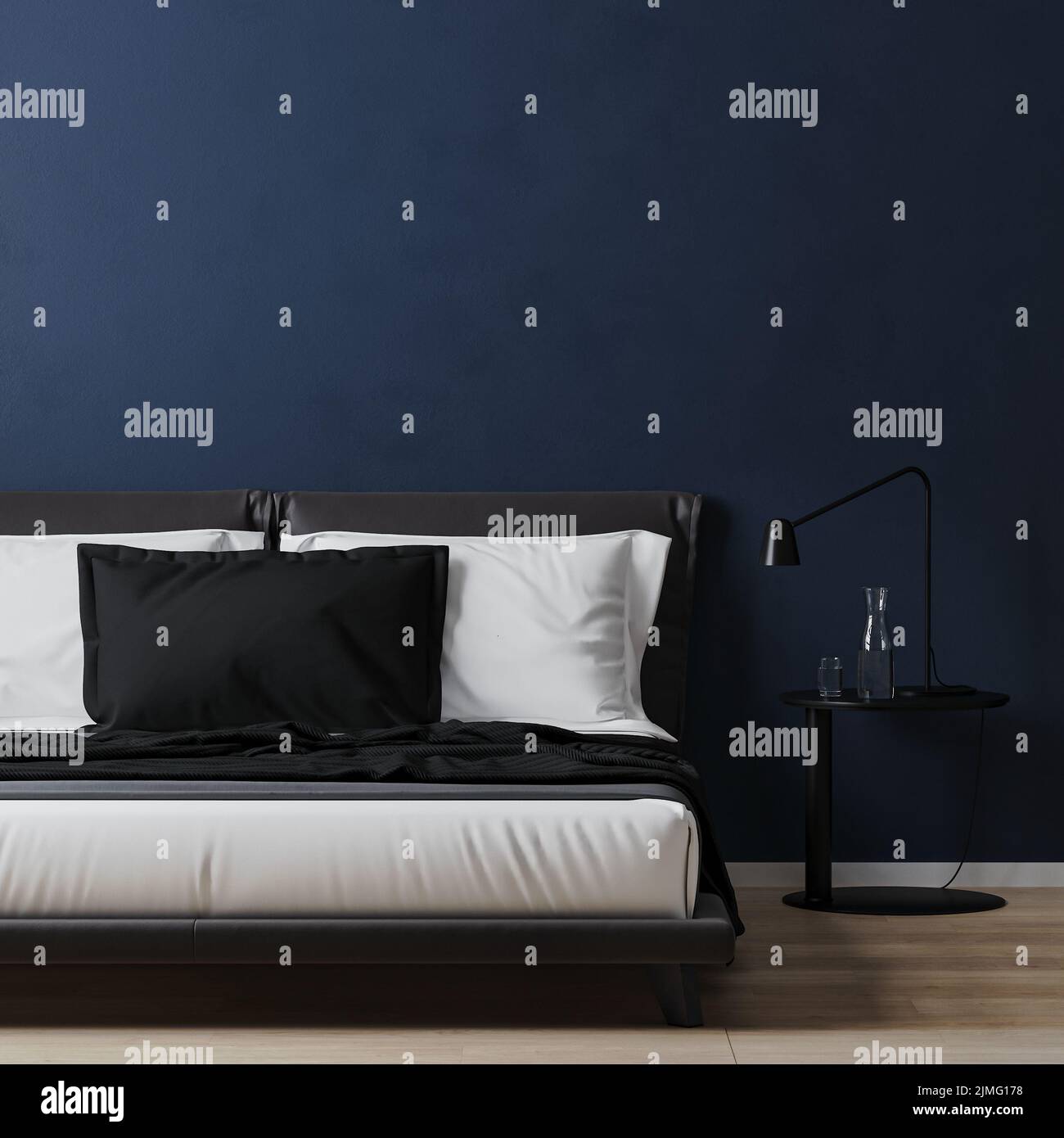 Bed with white and blue pillows with bedding table in room with dark