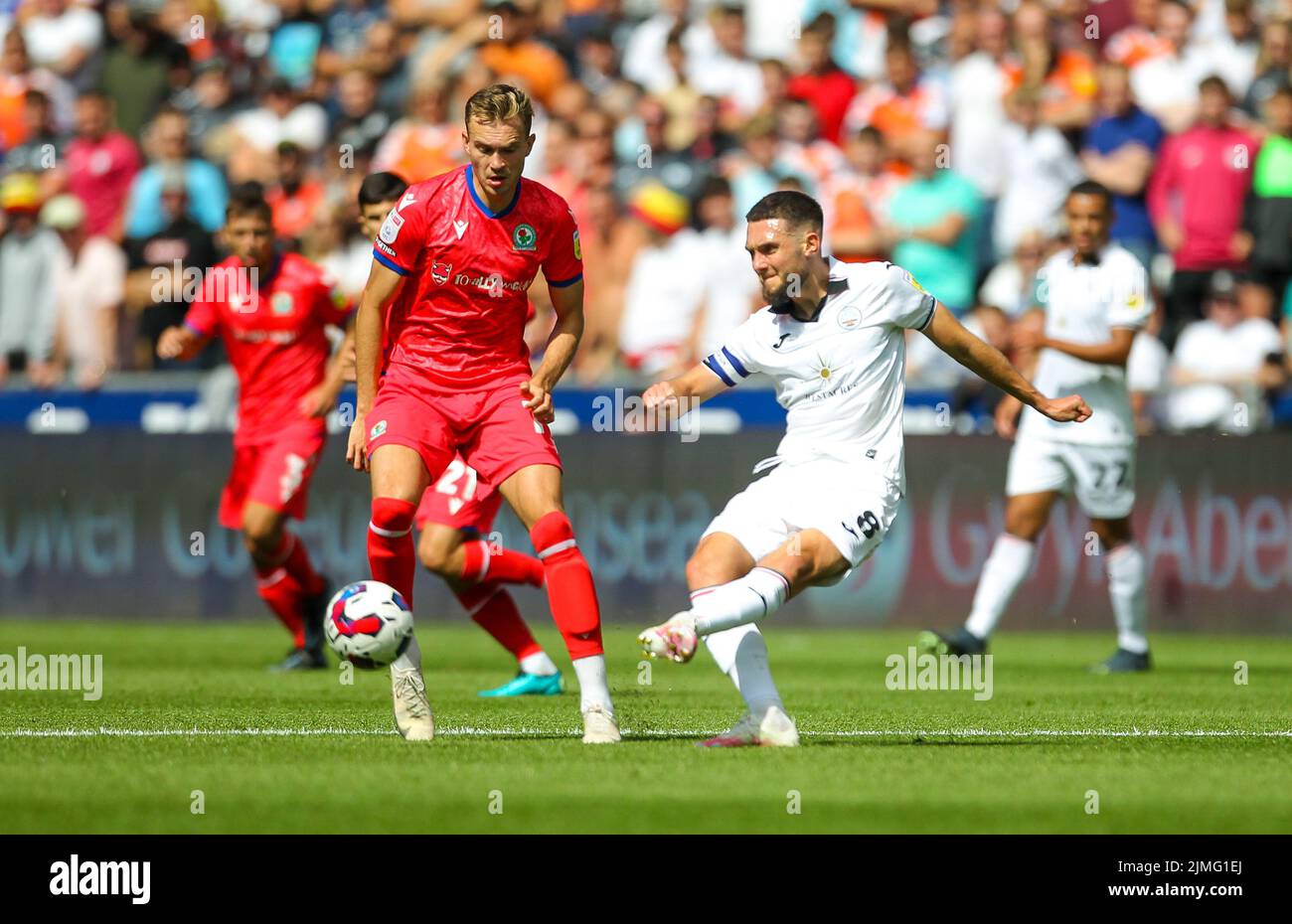 6th August 2022; Swansea.com stadium, Swansea, Wales; Championship football, Swansea versus Blackburn: Matt Grimes of Swansea City passes while under pressure from Ryan Hedges of Blackburn Rovers Stock Photo