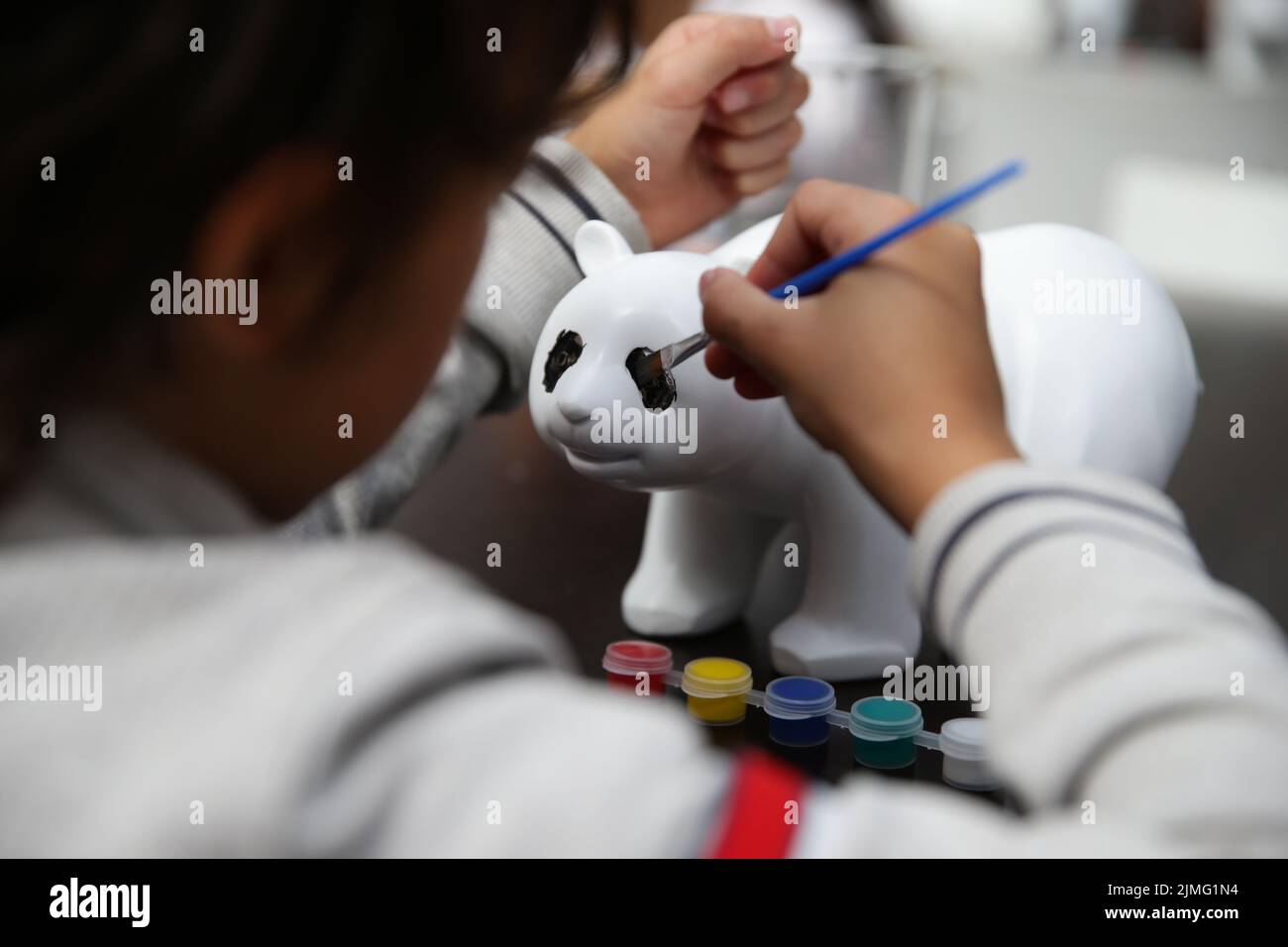 Brugelette, Belgium. 6th Aug, 2022. A child colors a giant panda doll during a celebration activity of the third birthday of the panda twins Bao Di and Bao Mei at the Pairi Daiza zoo in Brugelette, Belgium, Aug. 6, 2022. The celebration of the third birthday of the panda twins Bao Di and Bao Mei, born on Aug. 8, 2019 to Hao Hao and Xing Hui, was held at the Pairi Daiza zoo on Saturday. Credit: Zheng Huansong/Xinhua/Alamy Live News Stock Photo