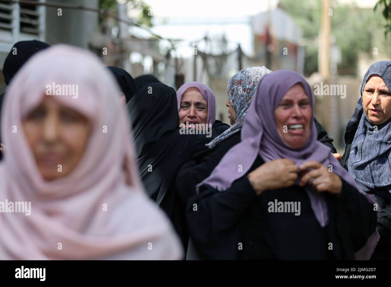 Khan Younis, Gaza Strip city of Khan Younis. 6th Aug, 2022. Women mourn during the funeral of Tamim Hijazi, 24, in the southern Gaza Strip city of Khan Younis, Aug. 6, 2022. At least 15 Palestinians have been killed and 125 injured as Israeli warplanes are continuing to strike military targets throughout the Gaza Strip for the second day on Saturday. Credit: Yasser Qudih/Xinhua/Alamy Live News Stock Photo