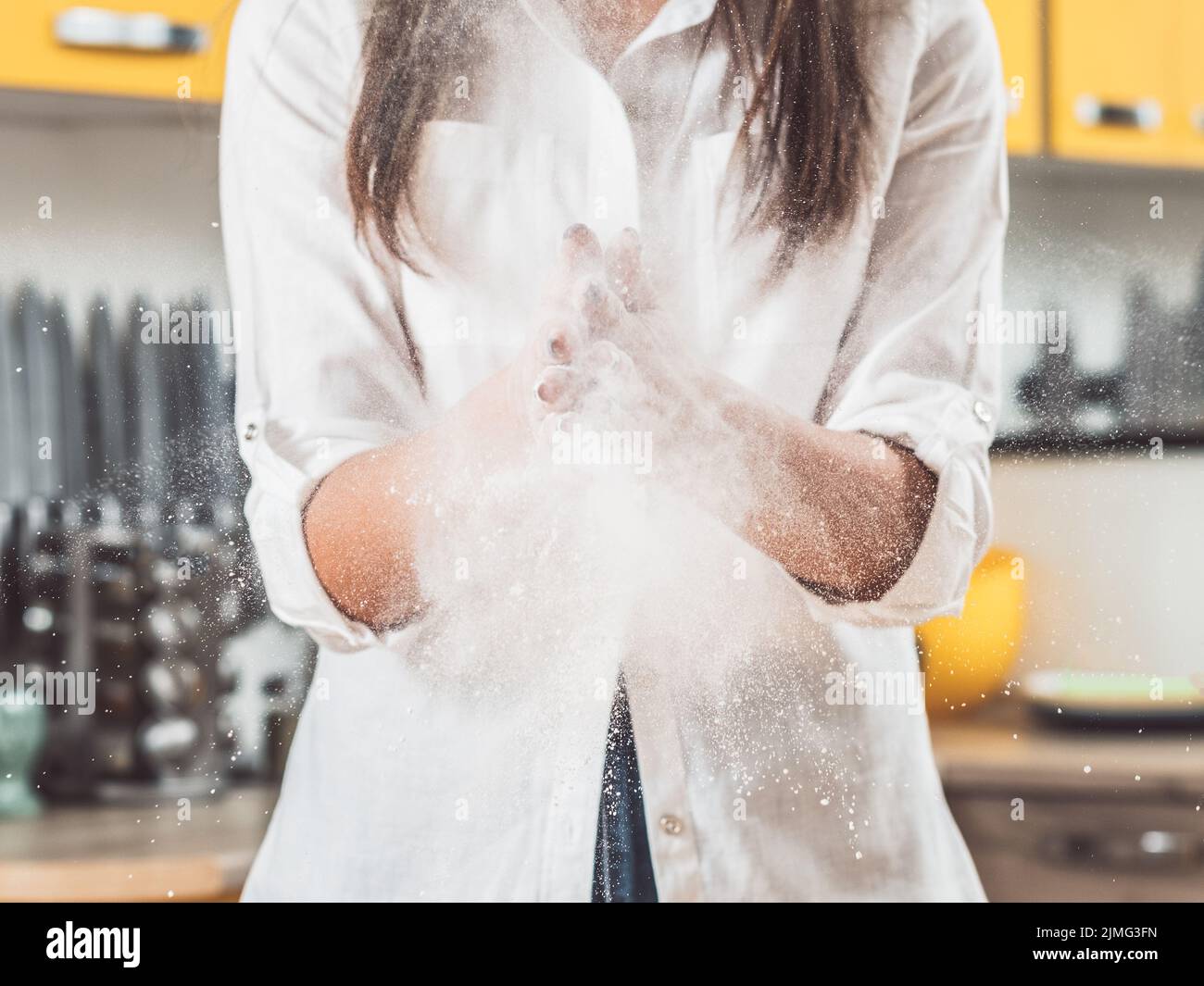 woman clapping hands flour dust cloud explosion Stock Photo Alamy