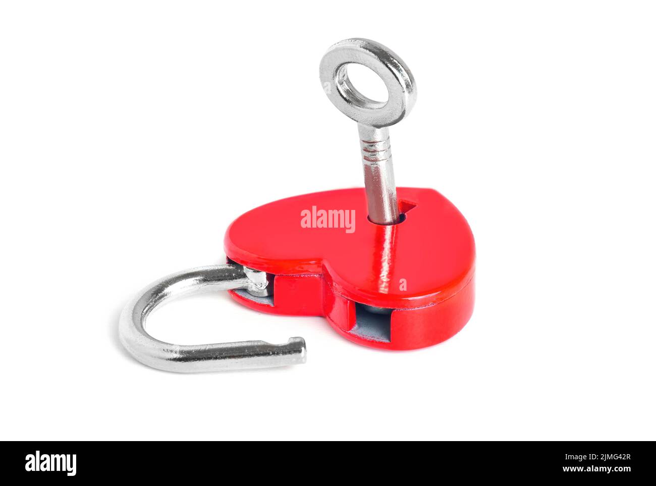 Silver-toned key in a small open red heart-shaped padlock isolated on ...