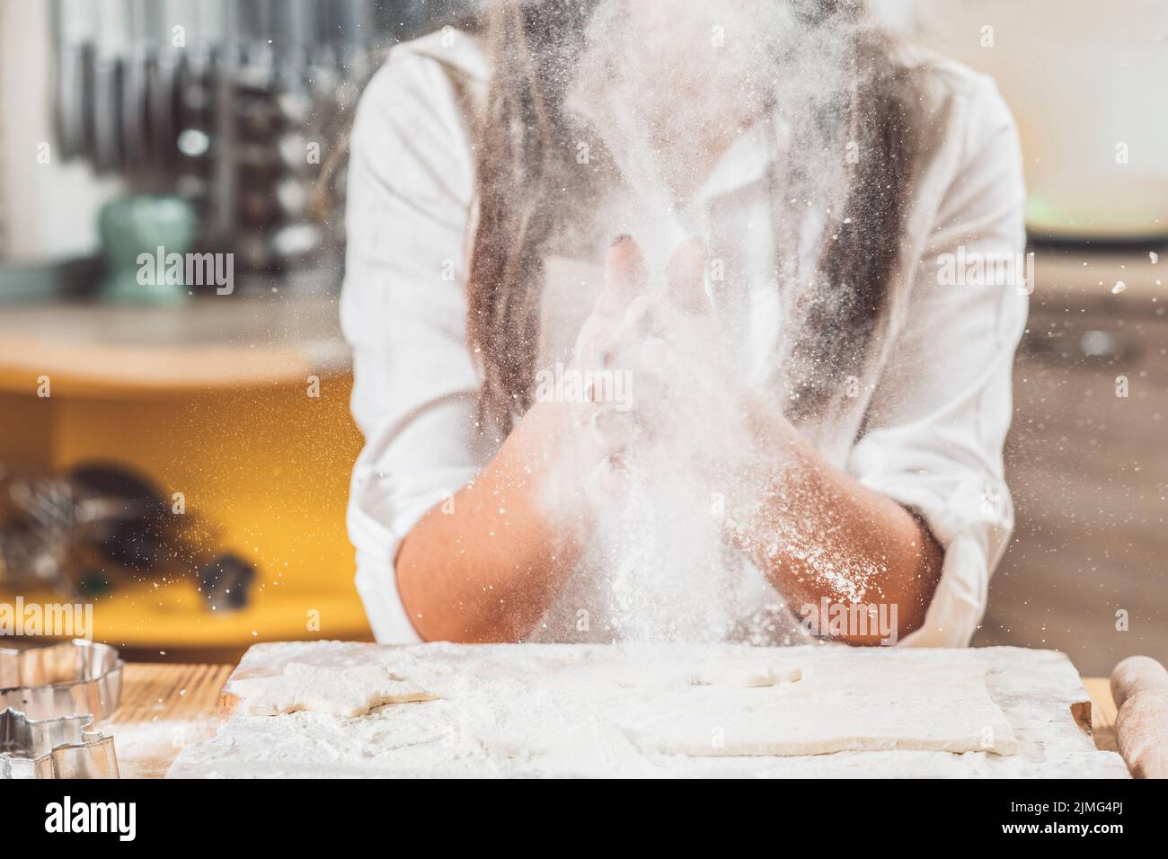woman clapping hands flour splatter baking leisure Stock Photo