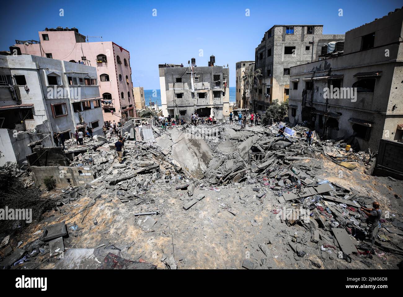 Palestinians inspect a damage building caused by an Israeli air strike in Sheikh Acleyn neighborhood in Gaza. The Israeli military launched deadly strikes against what it said were Islamic Jihad targets in Gaza as tensions continue to rise between Israel and Palestinian militant groups. Stock Photo