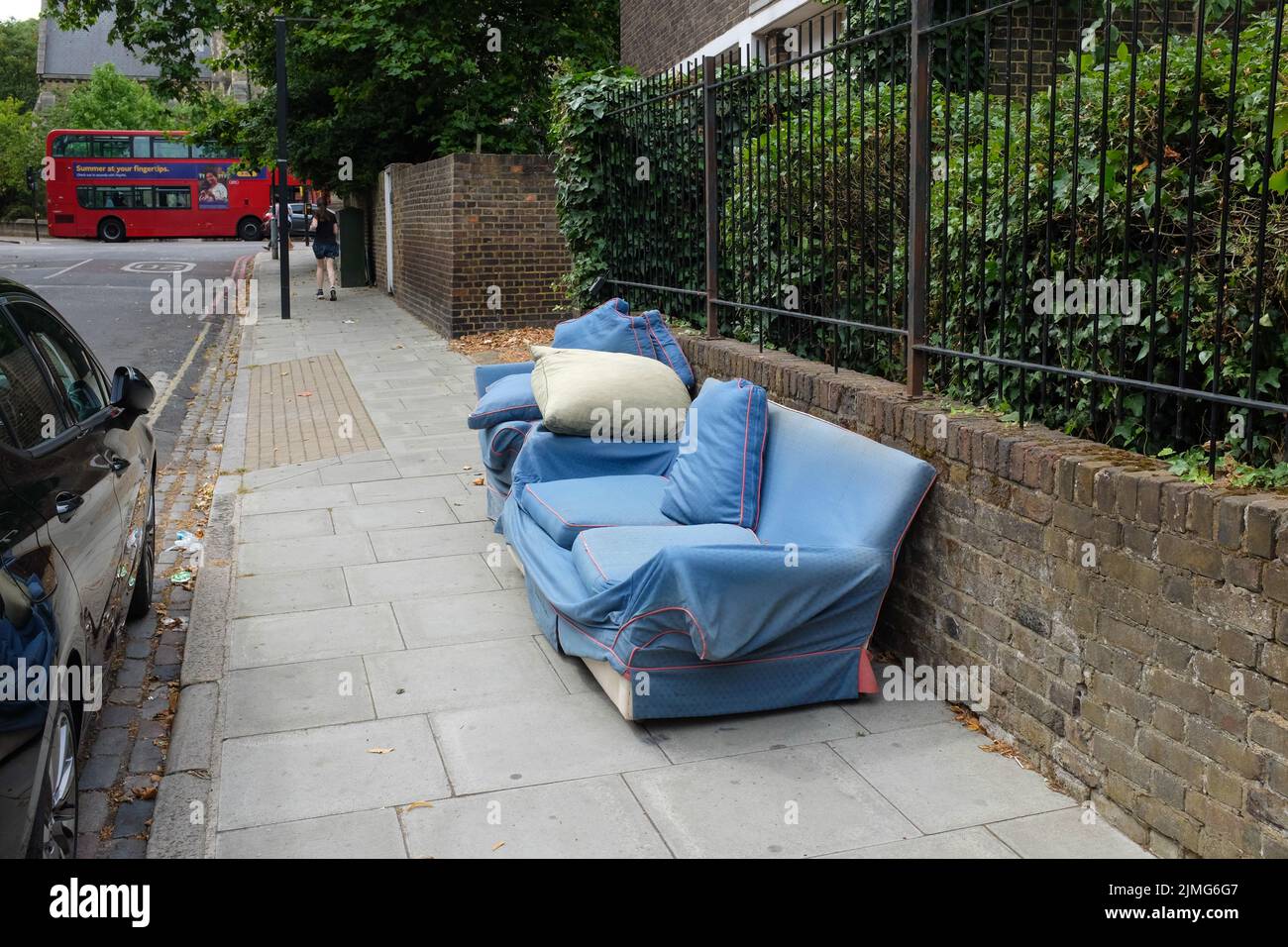 A dumped sofa on the streets of south London, England. Stock Photo