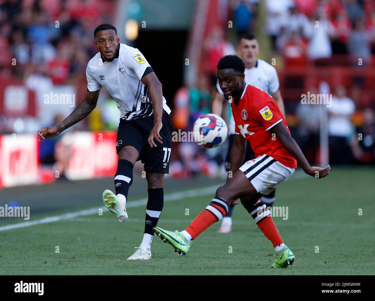Derby County's Nathaniel Mendez-Laing (left) passes the ball past Charlton Athletic's Steven Sessegnon during the Sky Bet League One match at The Valley, London. Picture date: Saturday August 6, 2022. Stock Photo