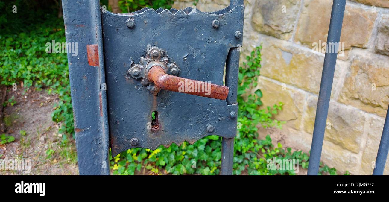 blue old door lock in front of a brick wall Stock Photo Alamy