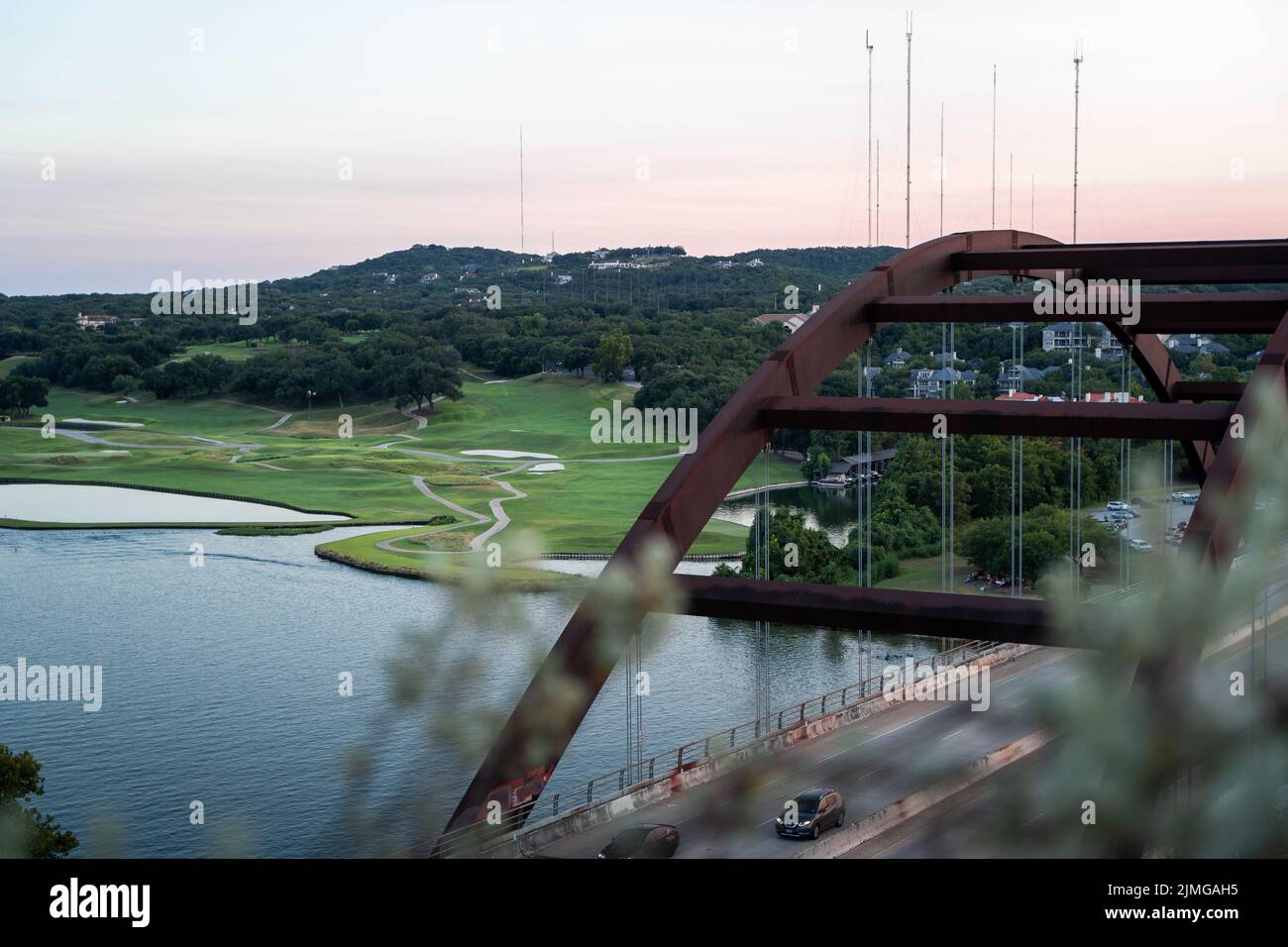 A beautiful view from 360 Overlook Bridge of the lush green lakeshore in Austin, Texas Stock Photo