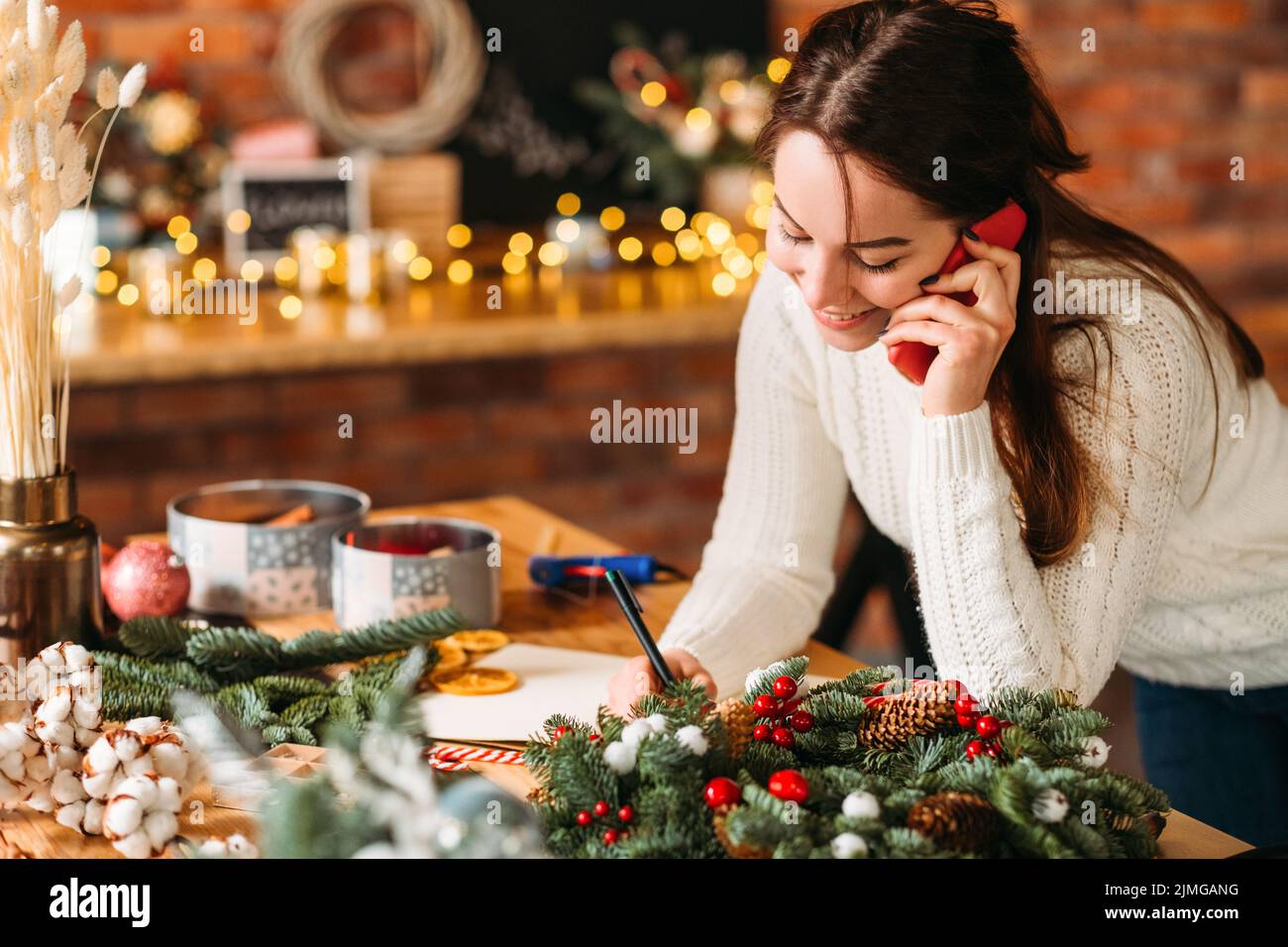 handmade gift shop lady receiving order phone Stock Photo