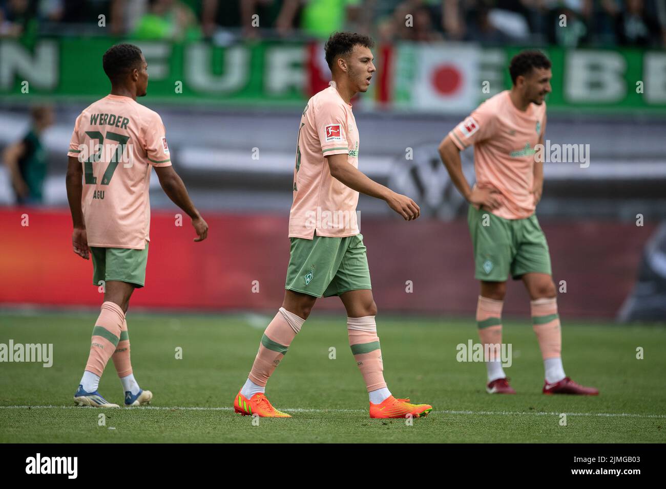 06 August 2022, Lower Saxony, Wolfsburg: Soccer, Bundesliga, VfL Wolfsburg - SV Werder Bremen, Matchday 1, Volkswagen Arena. Bremen's Lee Buchanan (m) and Bremen's Felix Agu (l) stand on the field after the match. Photo: Swen Pförtner/dpa - IMPORTANT NOTE: In accordance with the requirements of the DFL Deutsche Fußball Liga and the DFB Deutscher Fußball-Bund, it is prohibited to use or have used photographs taken in the stadium and/or of the match in the form of sequence pictures and/or video-like photo series. Stock Photo