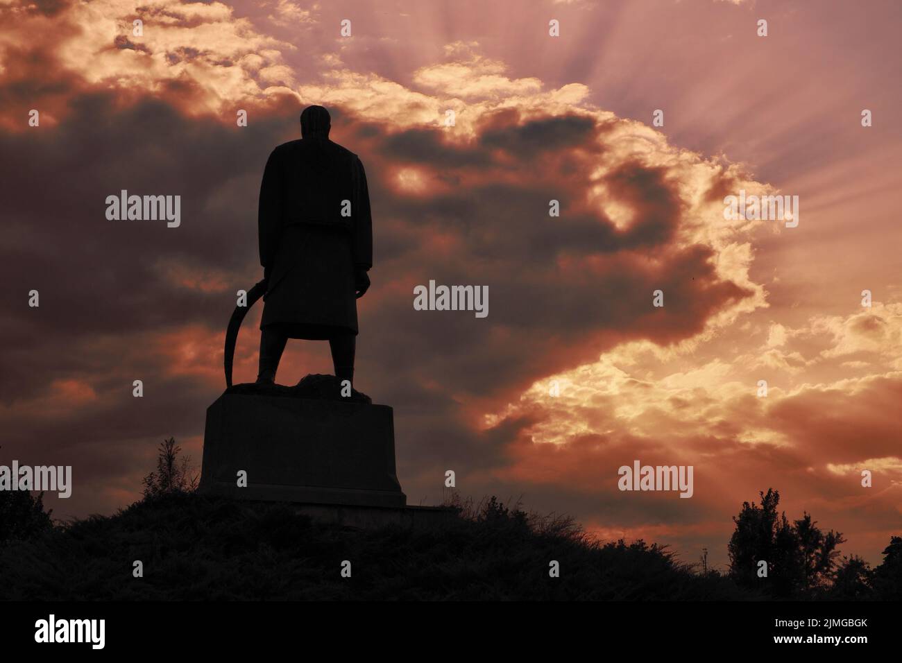 red dramatic sky at the sunset and silhouette of Karadjordje Statue in Belgrade, Serbia Stock Photo