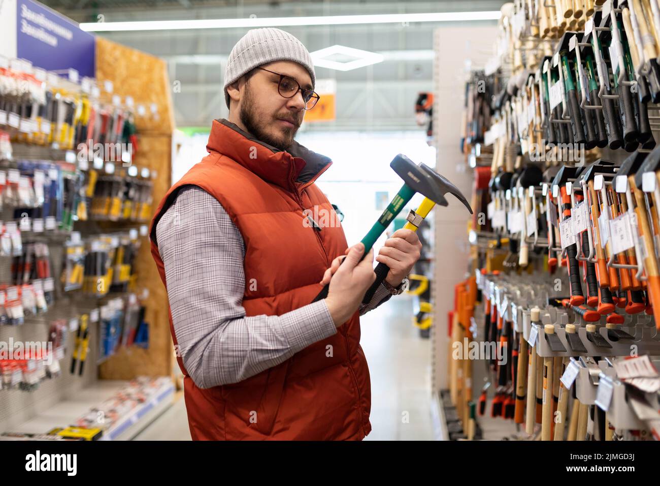 building materials stores a man chooses a new hammer Stock Photo Alamy
